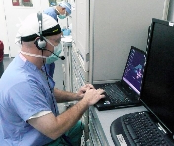 Lt. Col. (Dr.) John Mansfield's roaming network set-up of voice recognition software and the Medical Communications for Combat Casualty Care, or MC4, system enables him and other various specialists at the Air Force Theater Hospital at Balad Air Base, Iraq, to use hands-free devices to document patient care anywhere in the hospital using MC4 laptops.  (U.S. Air Force photo)