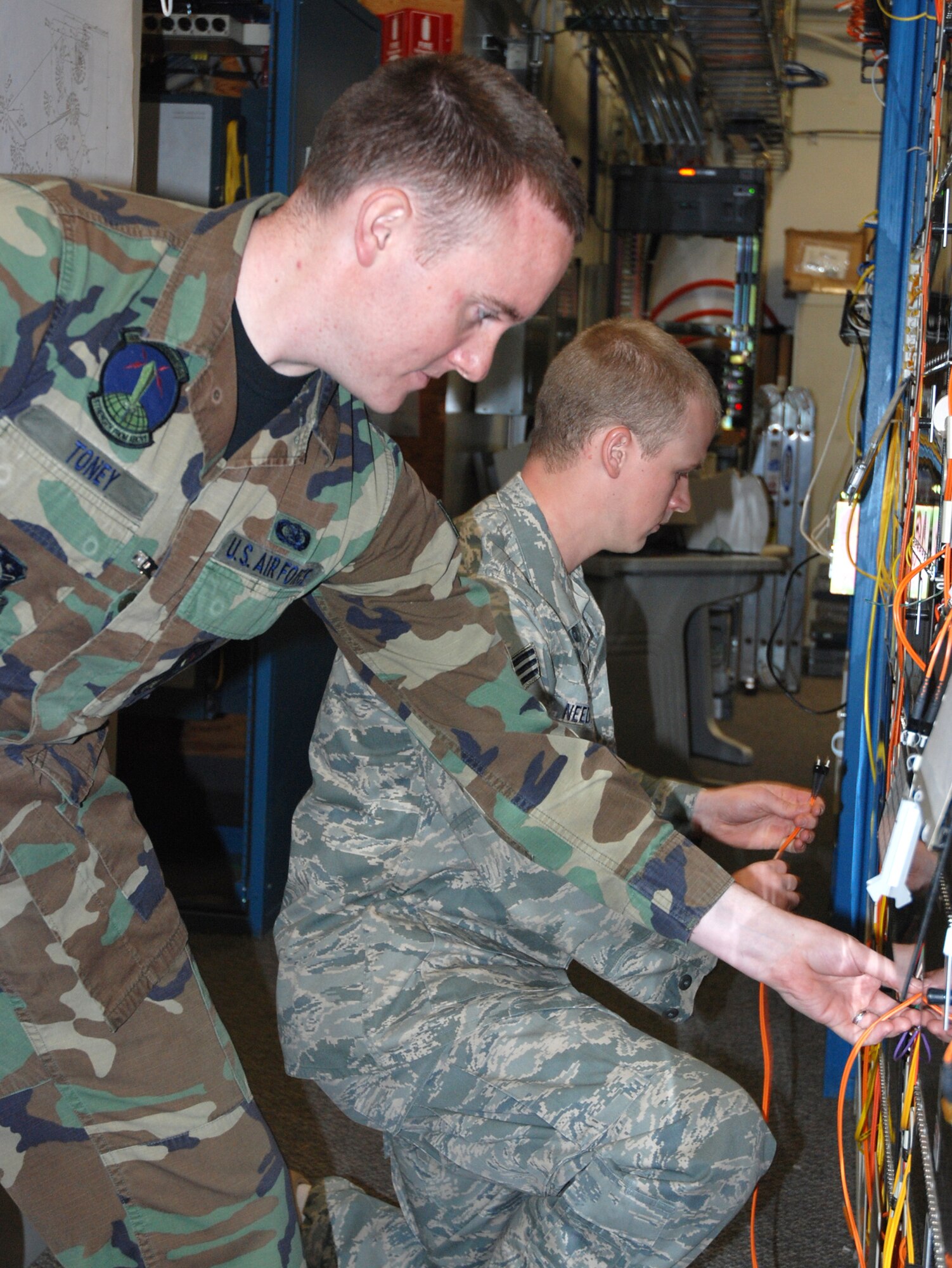 Senior Airmen Jeremiah Toney (left) and Jack Needham, 21st Space Communications Squadron technical controllers, perform operational checks on fiber cables before the 2008 Guardian Challenge competition April 22 at Peterson Air Force Base, Colo. The 21st SCS is competing against fellow communication squadrons at Buckley and Schriever AFBs in Colorado. The competition allows inspectors to determine which communications squadron is best at supporting a space mission through technical control functions.  (U.S. Air Force photo/Senior Airman Stephen Collier)