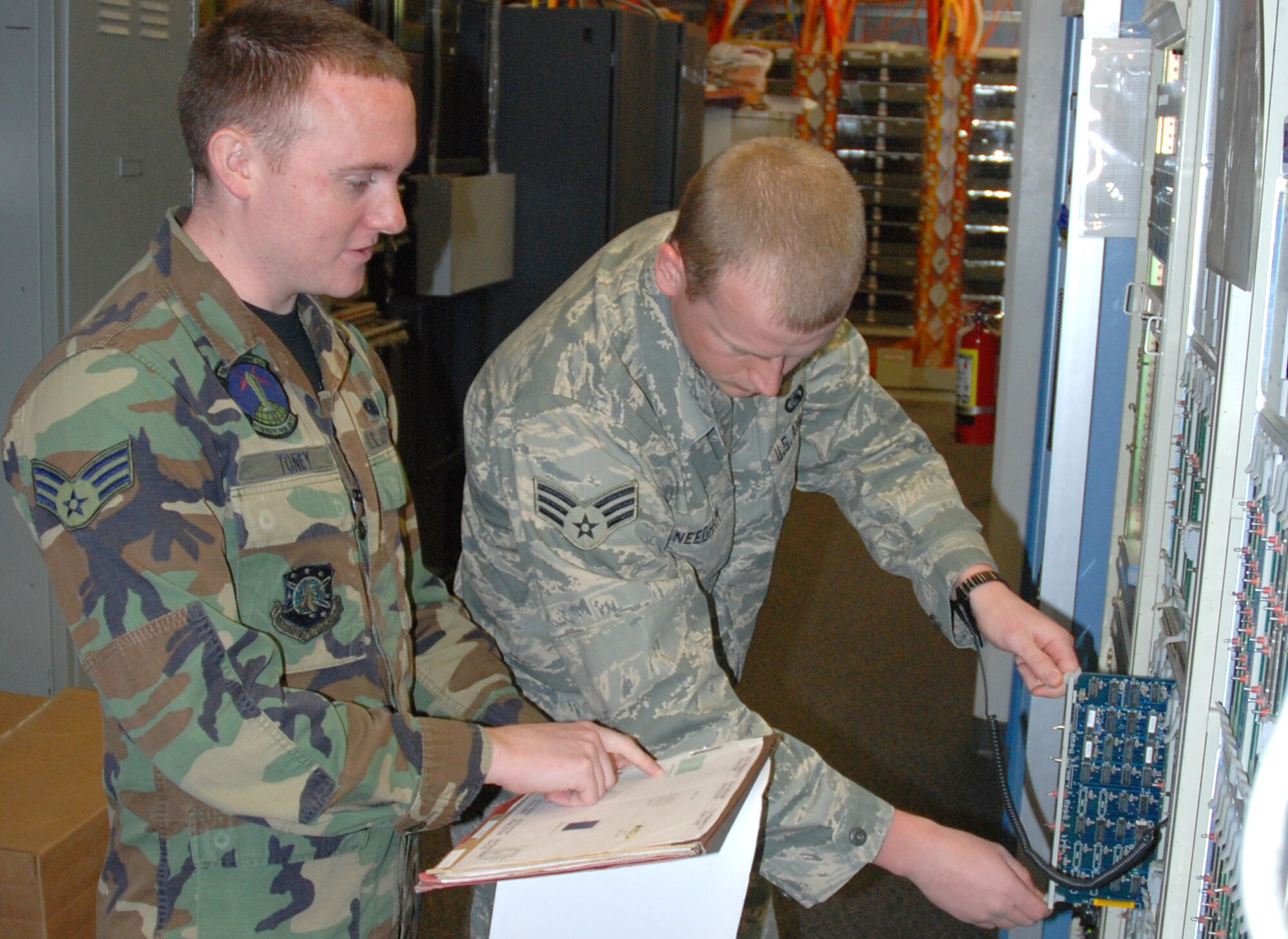 Senior Airmen Jeremiah Toney (left) and Jack Needham, 21st Space Communications Squadron technical controllers, simulate replacing a data card on a prominent node before the 2008 Guardian Challenge competition April 22 at Peterson Air Force Base, Colo. The 21st SCS is competing against fellow communications squadrons at Buckley and Schriever AFBs in Colorado. The competition allows inspectors to determine which communications squadron is best at supporting a space mission through technical control functions. (U.S. Air Force photo/Senior Airman Stephen Collier)