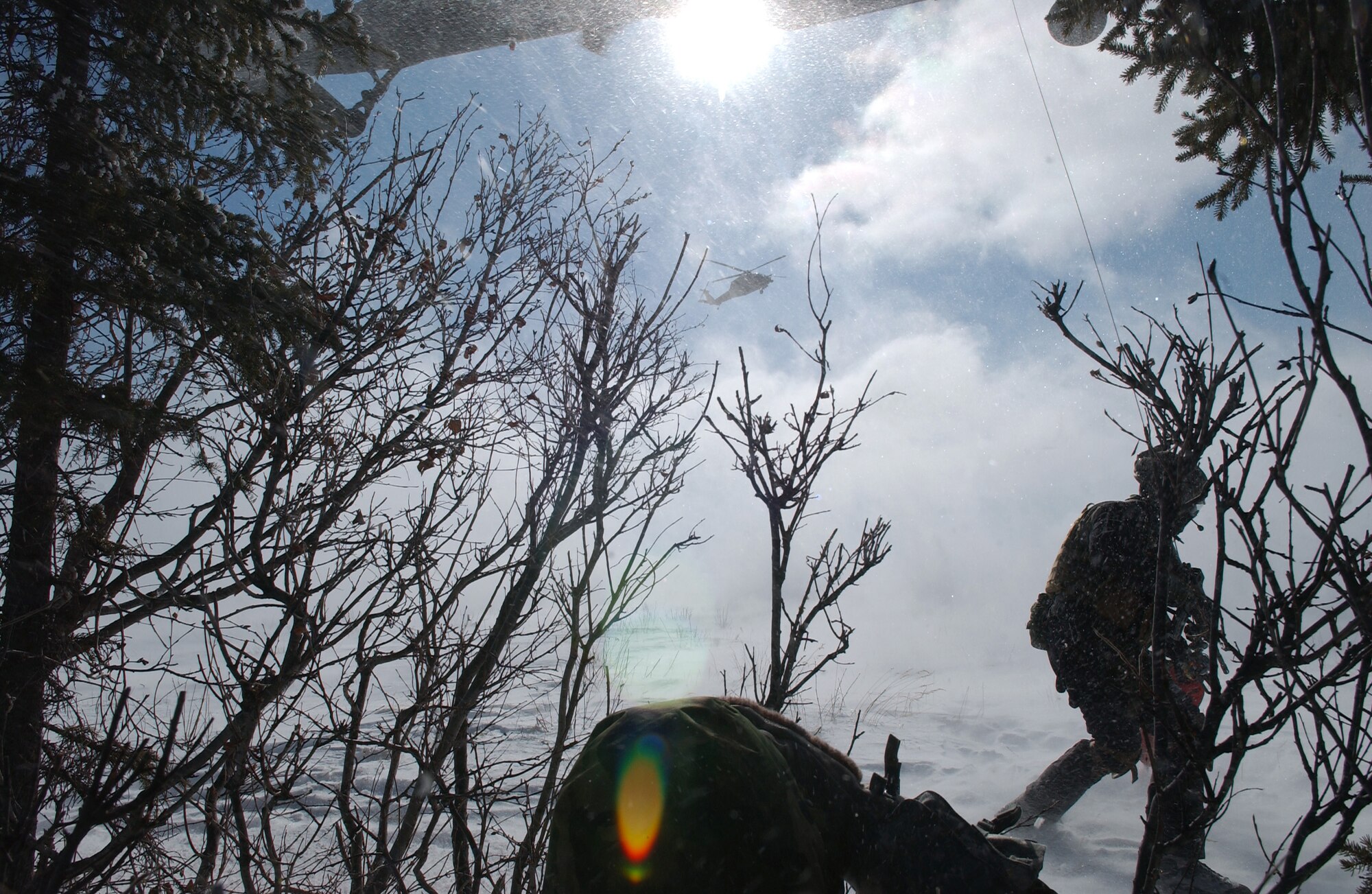 A survival, evasion, resistance and escape specialist repels safely to the ground from a HH-60 Pavehawk during RED FLAG-Alaska 08-2 April 16, 2008, at Eielson Air Force Base, Alaska. 1st Lt. Alex Goldberg is simulating as a downed pilot behind enemy lines and must communicate with the 33rd Rescue Squadron for extraction. Lieutenant Goldberg is a pilot of the 61st Fighter Squadron from Luke Air Force Base, Ariz. (U.S. Air Force Photo/Airman 1st Class Jonathan Snyder)