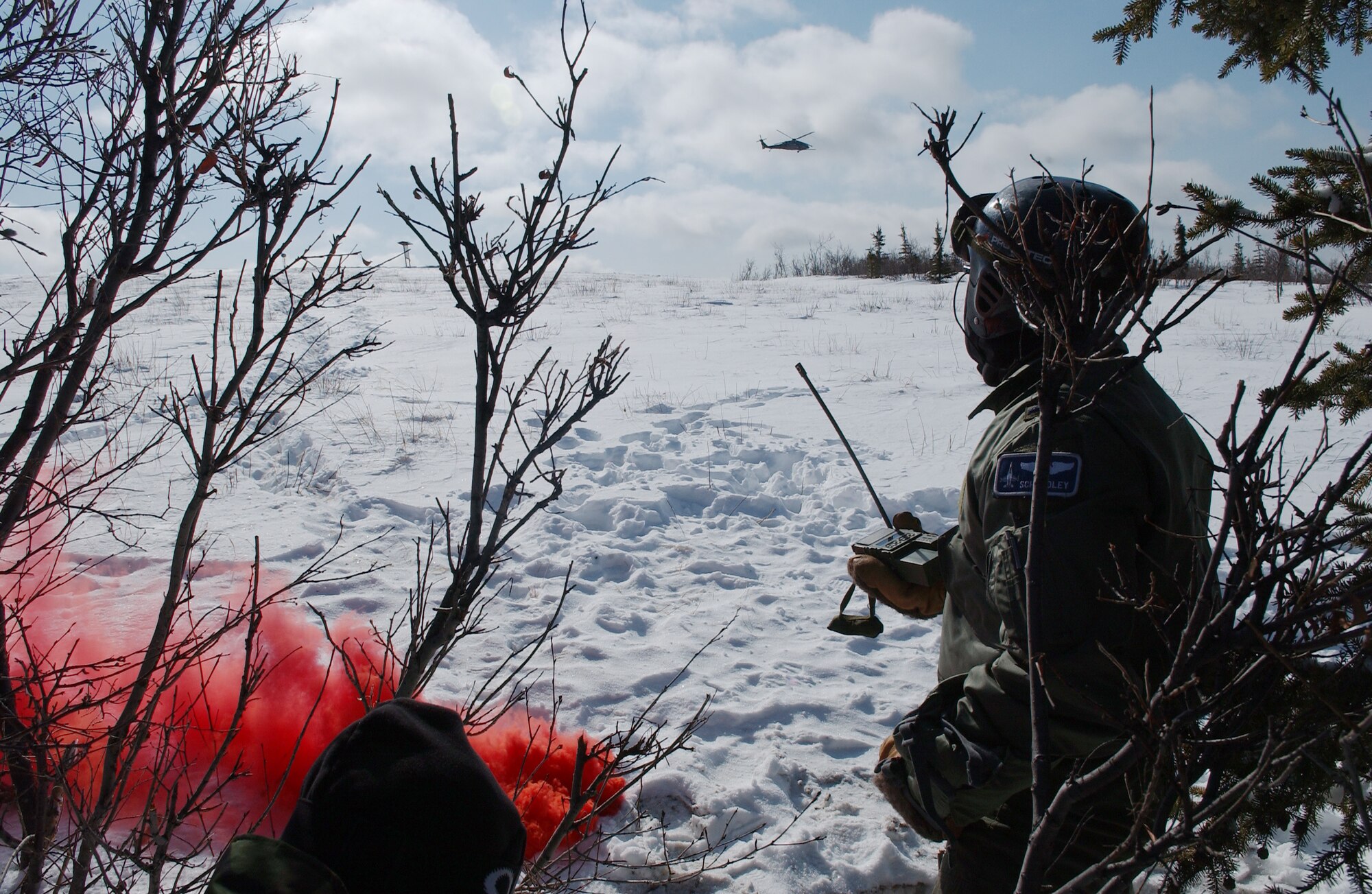1st Lt. Alex Goldberg pops smoke to help the HH-60 Pavehawk find his location during RED FLAG-Alaska 08-2 April 16, 2008, at Eielson Air Force Base, Alaska. Lieutenant Goldberg is simulating as a downed pilot behind enemy lines and must communicate with the 33rd Rescue Squadron for extraction. Lieutenant Goldberg is a pilot of the 61st Fighter Squadron from Luke Air Force Base, Ariz. (U.S. Air Force Photo/Airman 1st Class Jonathan Snyder)