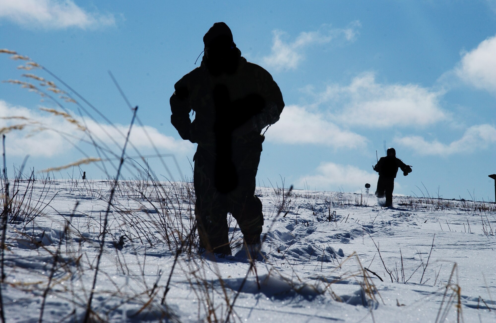 Staff Sgt. Jason Mihal, front, and 1st Lt. Alex Goldberg, back, move through the snow seeking cover while employing his evasion and survival training during RED FLAG-Alaska 08-2 April 16, 2008, at Eielson Air Force Base, Alaska. Lieutenant Goldberg is simulating as a downed pilot behind enemy lines and must communicate with the 33rd Rescue Squadron for extraction. Sergeant Mihal is a survival, evasion, resistance and escape instructor of the 353rd Combat Training Squadron. Lieutenant Goldberg is a pilot of the 61st Fighter Squadron from Luke Air Force Base, Ariz. (U.S. Air Force
Photo/Airman 1st Class Jonathan Snyder)