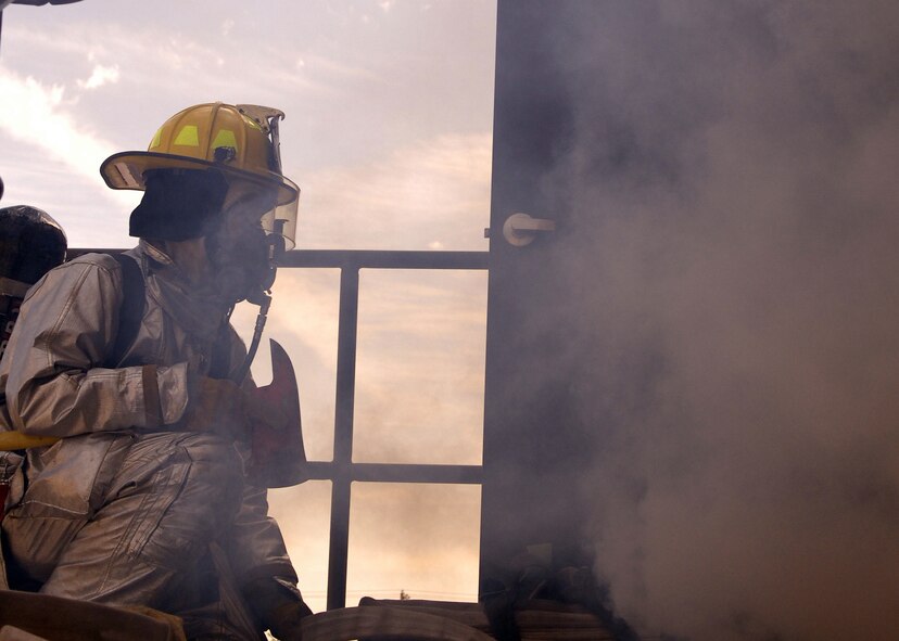 DYESS AIR FORCE BASE, Texas -- Airman Justin McNeese awaits his team outside the second floor of the new fire station as they perform a structural exercise and a rescue operation April 16. It is mandatory for the firemen to perform this exercise once a month to be evaluated on teamwork and efficiency. The fire department has assigned 21 fire fighters for the base and work in teams of five during real emergencies.  (U.S. Air Force photo by Staff Sergeant Connor W. Estes)  