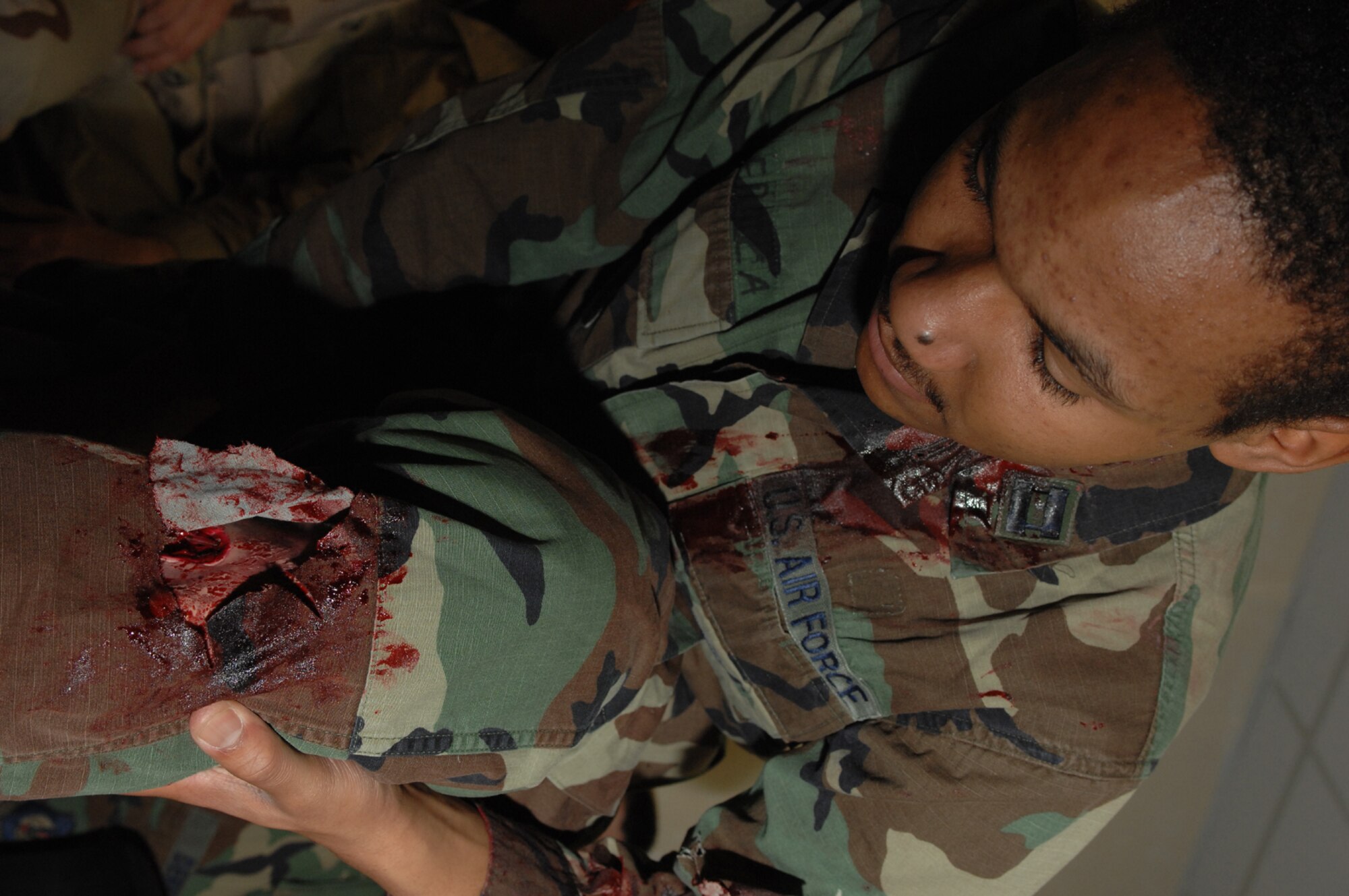SPANGDAHLEM AIR BASE, Germany -- Airman Brandon Proctor, 606th Air Control Squadron, checks out his new moulage injury during Exercise Saber Crown 08-06, April 22, 2008. (U.S. Air Force photo/Staff Sgt. Kristin Ruleau) 