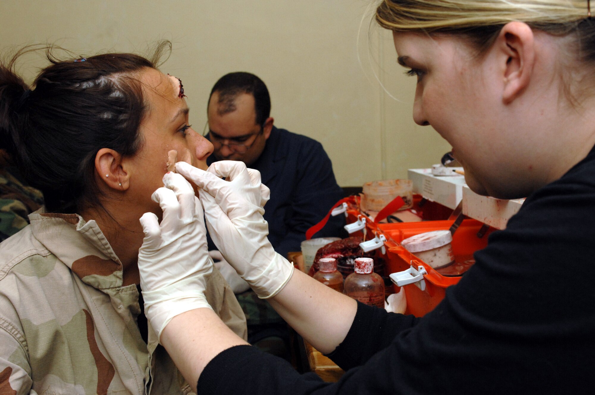 SPANGDAHLEM AIR BASE, Germany -- Megan Caberto, daughter of Col. Steven Caberto, 52nd Medical Group deputy commander, receives a facial laceration moulage from Senior Airman Bridget Borseth, 52nd Dental Squadron, during Exercise Saber Crown 08-06, April 22, 2008. (U.S. Air Force photo/Staff Sgt. Kristin Ruleau) 