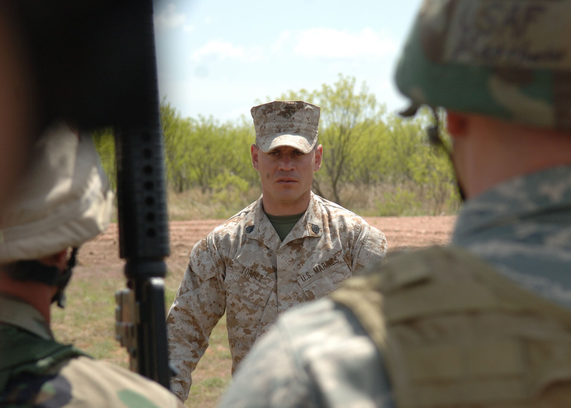 DYESS AIR FORCE BASE, Texas -- Marine Staff Sergeant  Pablo Torrez Briefs a group of Airmen before engaging in a convoy training environment April 17. Sergeant Torrez briefed the Airmen on techniques used to properly eliminate hostile forces while on a convoy. (U.S. Air Force Photo by Airman 1st Class Micheal Breaux)