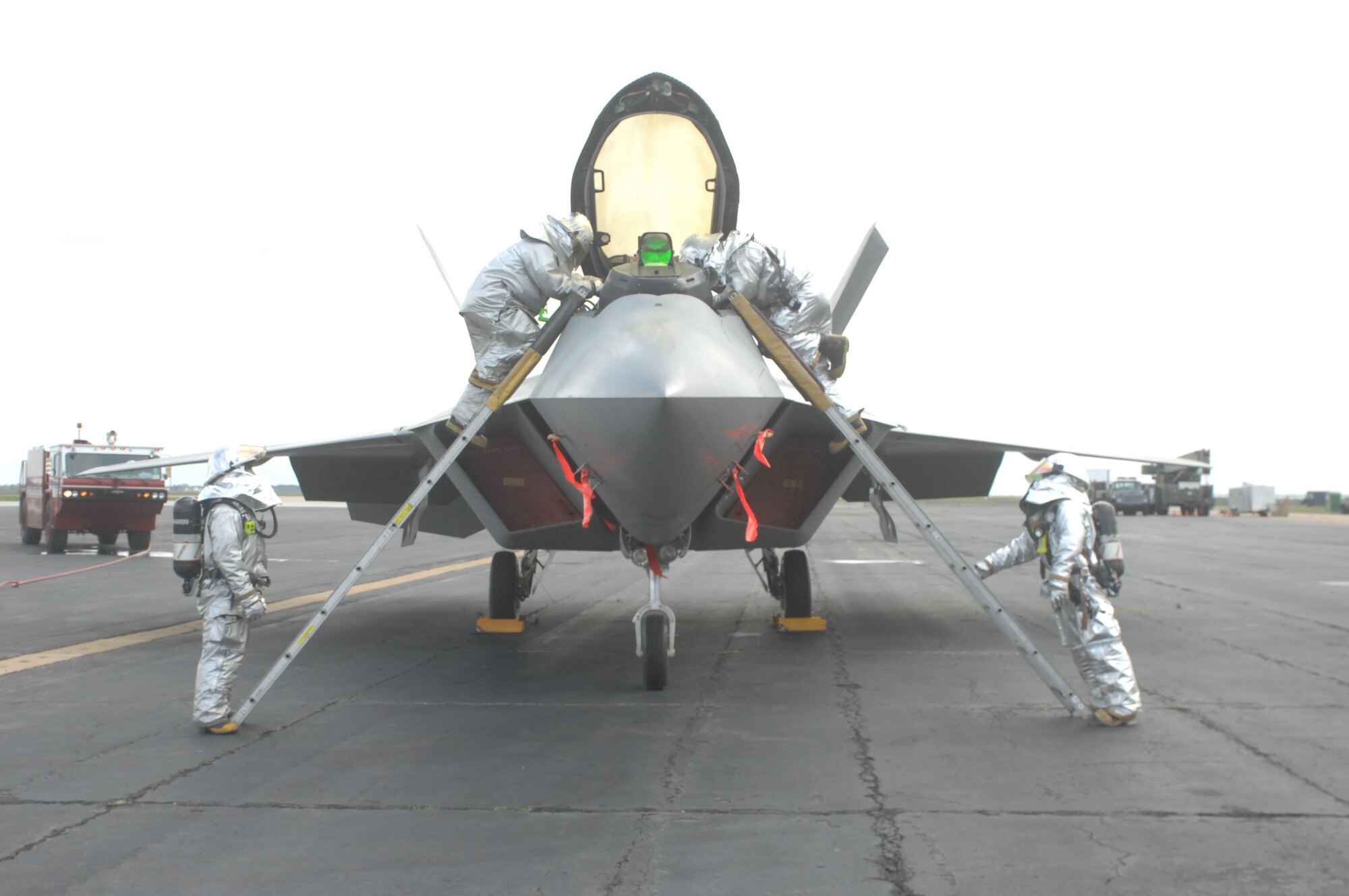 Firefighters from the 1st Fighter Wing prepare to extract a pilot from an F-22 Raptor during an Operational Readiness Inspection April 14.  Airmen from the 1st and 192nd Fighter Wings were tested on their ability to survive and operate in a deployed environment. (U.S. Air Force Photo/Master Sgt. Carlos Claudio) 