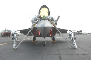 Firefighters from the 1st Fighter Wing prepare to extract a pilot from an F-22 Raptor during an Operational Readiness Inspection April 14.  Airmen from the 1st and 192nd Fighter Wings were tested on their ability to survive and operate in a deployed environment. (U.S. Air Force Photo/Master Sgt. Carlos Claudio) 