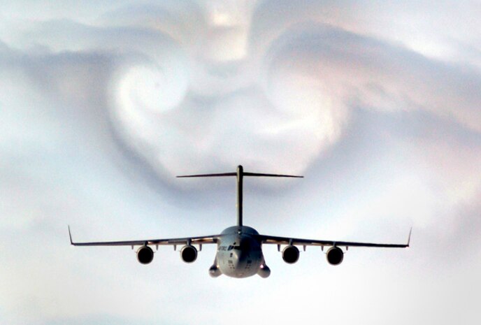 A C-17 parts the clouds over western South Carolina during a training mission Feb. 2, 2003. The C-17 Globemaster III is the newest, most flexible cargo aircraft in the Air Force.   (U.S. Air Force photo/Staff Sgt. Myles Cullen)