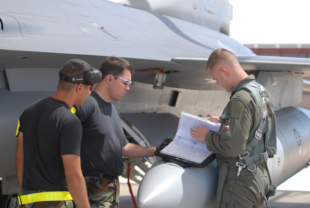 Airman First Class Stephen Case and Staff Sgt. Jason Blataric, crew chiefs with the 149 Fighter Wing (FW), Texas Air National Guard, San Antonio, Texas, discuss maintenance logs with First Lt. Aaron Bandy during a pre-flight inspection.  The airmen are deployed to Davis-Monthan Air Force Base, Tucson, Arizona in support of Coronet Cactus, an annual 149FW exercise.  (Air National Guard photo by SSgt Andre' Bullard)(RELEASED)