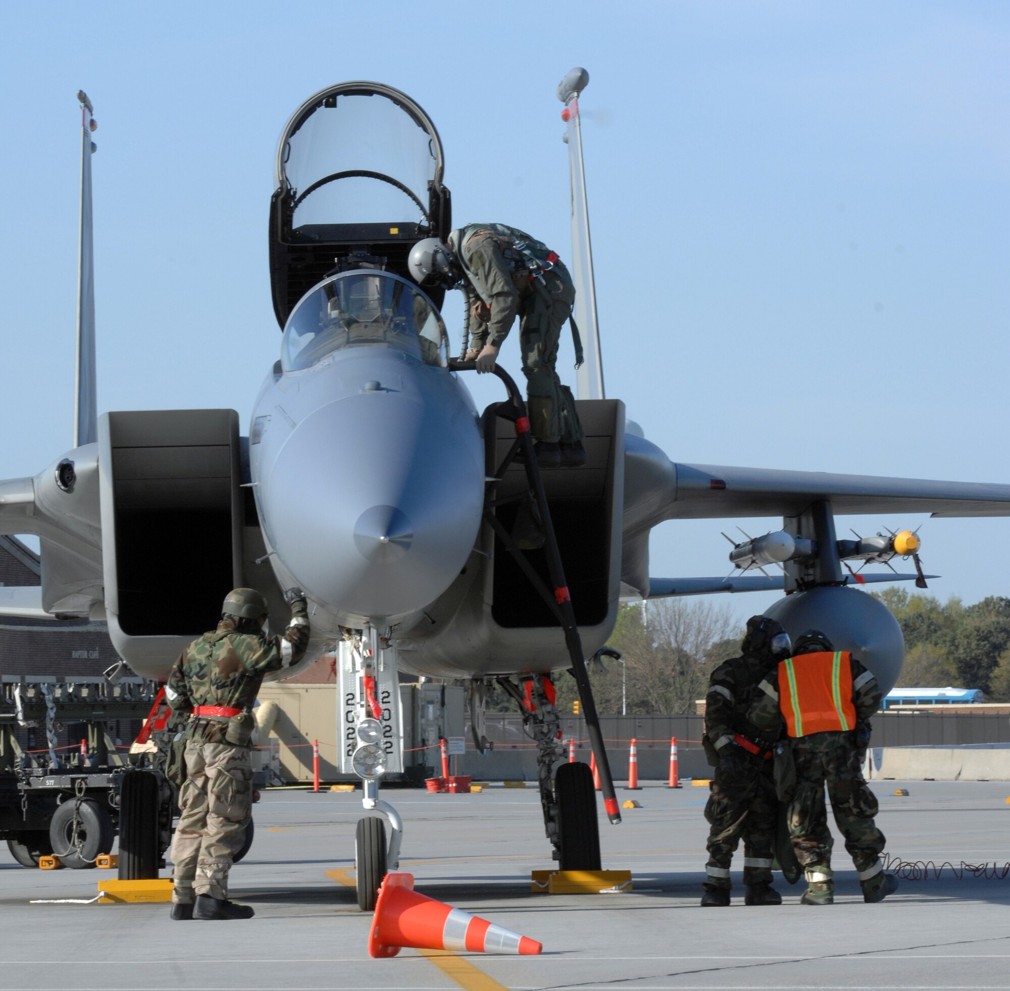 Airmen from the 71st Fighter Squadron perform maintenance during an Operational Readiness Inspection April 15 while wearing chemical protective gear.  The ORI tested Airmen's ability to survive and operate in a deployed environment.  (U.S. Air Force photo/Senior Airman Vernon Young)