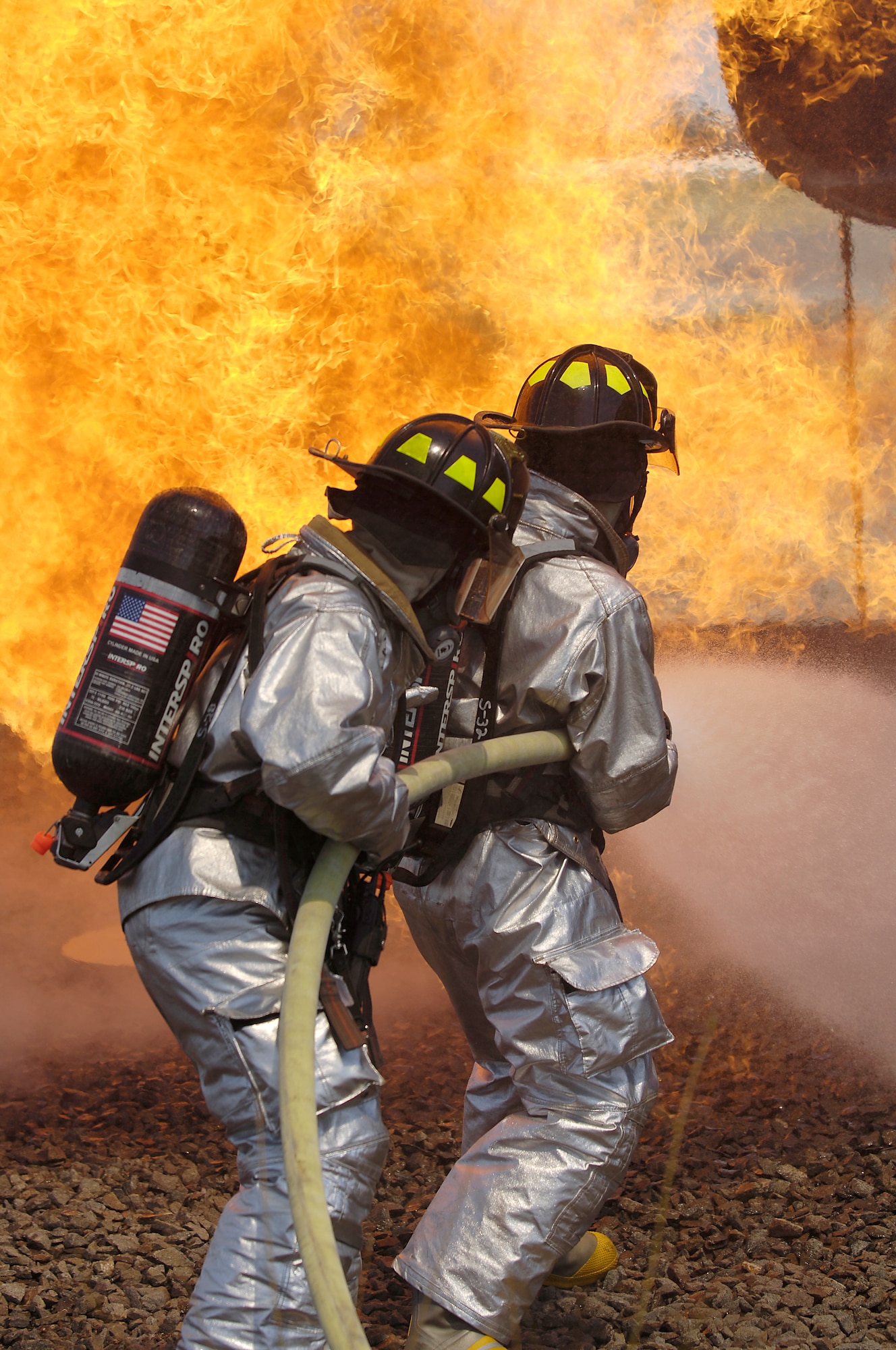 Senior Airman Dustin Borton and Colin Cathrew, both 305th Civil Engineer Squadron firefighters, McGuire Air Force Base, N.J., fight an aircraft fire during a Major Accident Response Exercise recently here. Exercises, like the MARE, prepare McGuire initial responders to be ready for anything. (U.S. Air Force photo/Kenn Mann) 