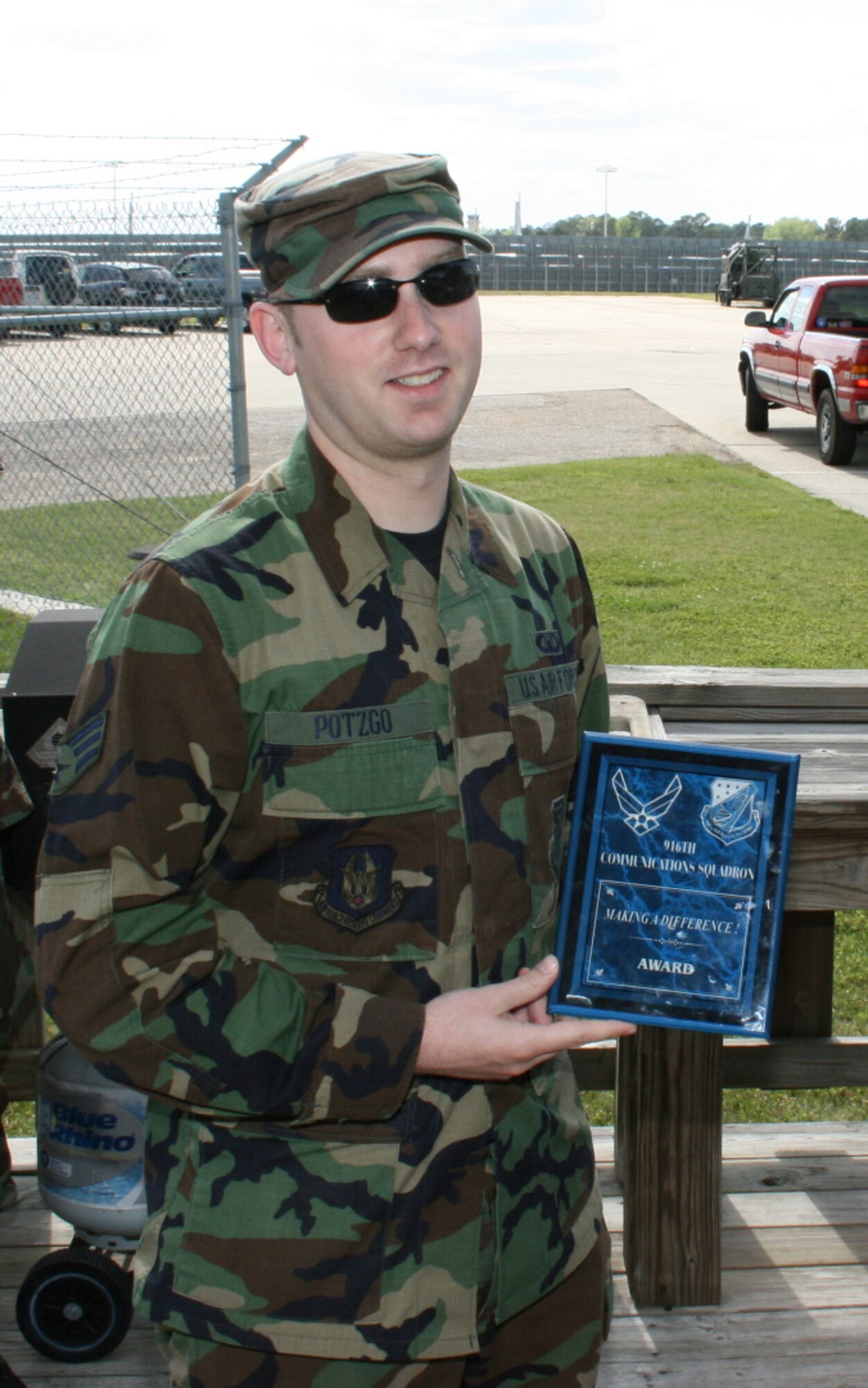 SEYMOUR JOHNSON AIR FORCE BASE, N.C. -- Senior Airman George Potzgo proudly displays his Making a Difference Award for his outstanding contributions in preparation for the 916th Communication Squadron unit training assembly. The squadron award was created by Senior Master Sgt. Brian Bischoff as a wayto recognize non-senior NCOs for their participation in the squadron and for bettering themselves. Airman Potzgo is a information manager.