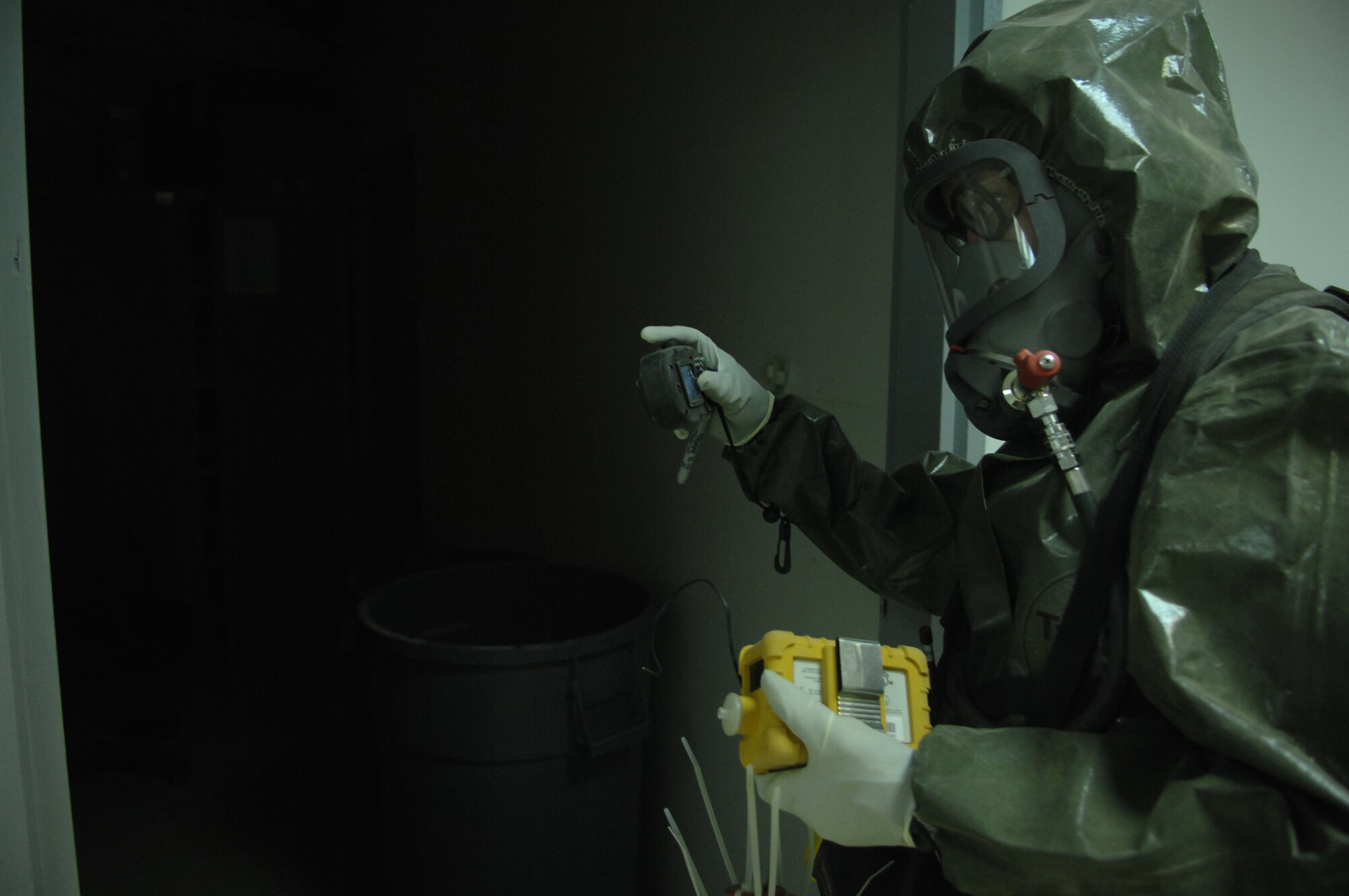 BALAD AIR BASE, Iraq -- Staff Sgt. Amber Albano, 506th Expeditionary Civil Engineer Squadron emergency manager from Kirkuk Regional Air Base, pauses before walking into a room containing an unknown powder substance during a training event here, April 17. Training scenarios allow emergency managers to practice using their equipment, so if a real world situation occurred, they would be ready. Sergeant Albano is deployed from Beale Air Force Base, Calif. (U.S. Air Force photo/ Senior Airman Julianne Showalter)