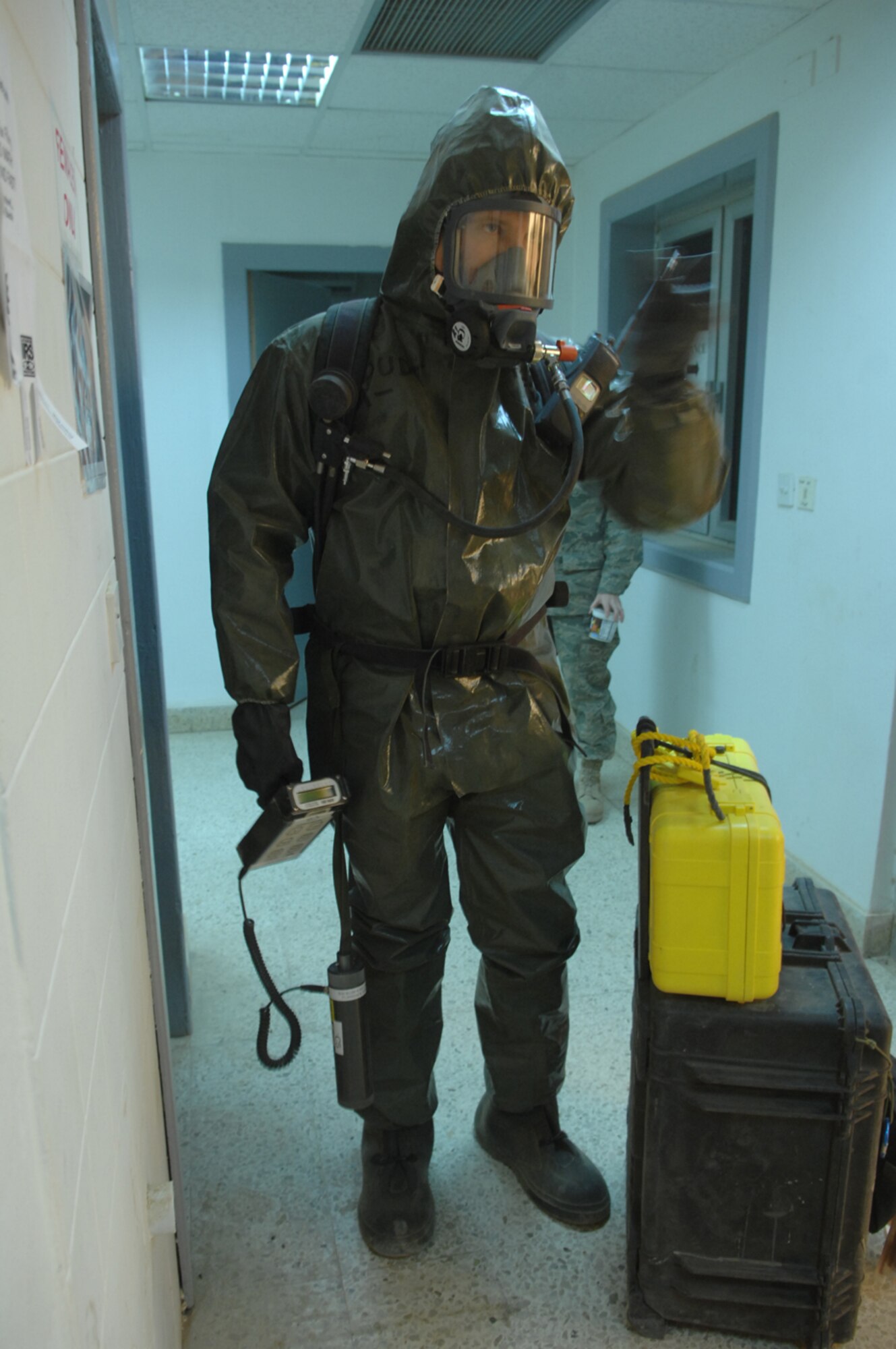 BALAD AIR BASE, Iraq -- Senior Master Sgt. Thomas Stoudt, deployed to Southwest Asia as the functional manager for the emergency management career field, shakes a light stick as he proceeds down a hallway while seeking out an unknown powder substance during a training event, April 17. The training session was one of many that Airmen from Balad, Kirkuk Regional Air Base, Ali Base and Al Asad Airfield participated in during a week-long emergency management training session that concluded April 19. Sergeant Stoudt is deployed from Air National Guard Headquarters, Washington D.C. (U.S. Air Force photo/ Senior Airman Julianne Showalter)