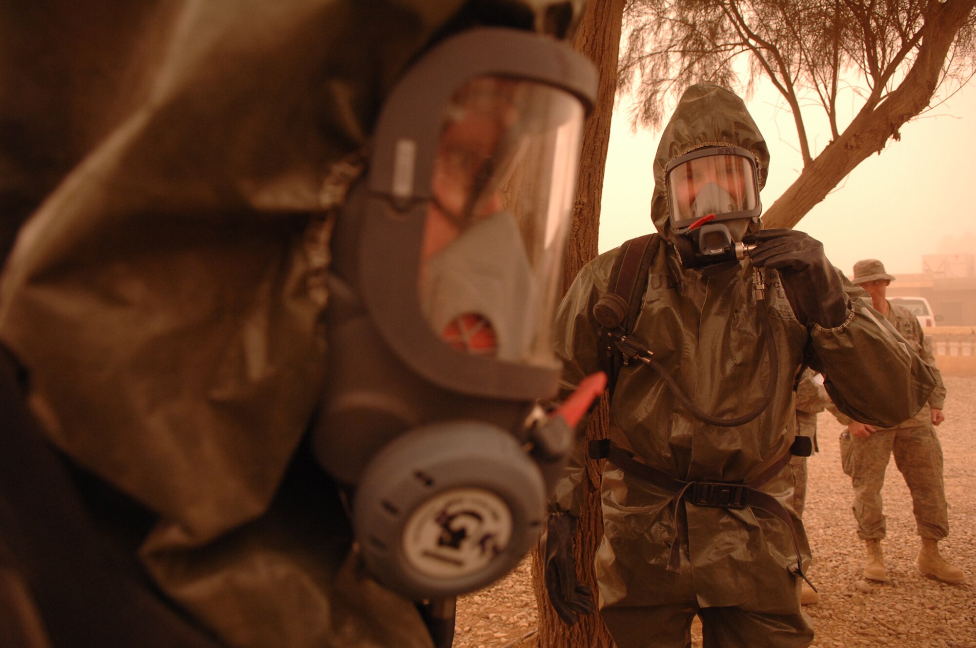 BALAD AIR BASE, Iraq -- Staff Sgt. Amber Albano, 506th Expeditionary Civil Engineer Squadron emergency manager from Kirkuk Regional Air Base, and Senior Master Sgt. Thomas Stoudt, deployed to Southwest Asia as the functional manager for the emergency management career field, prepare to enter a building containing an unknown powder substance during a training scenario here, April 17. The scenario was one of many that Airmen from Balad, Kirkuk, Ali Base and Al Asad Airfield participated in during a week-long emergency management training session that concluded April 19. Sergeant Albano is deployed from Beale Air Force Base, Calif.; Sergeant Stoudt is deployed from Air National Guard Headquarters, Washington D.C. (U.S. Air Force photo/ Senior Airman Julianne Showalter)