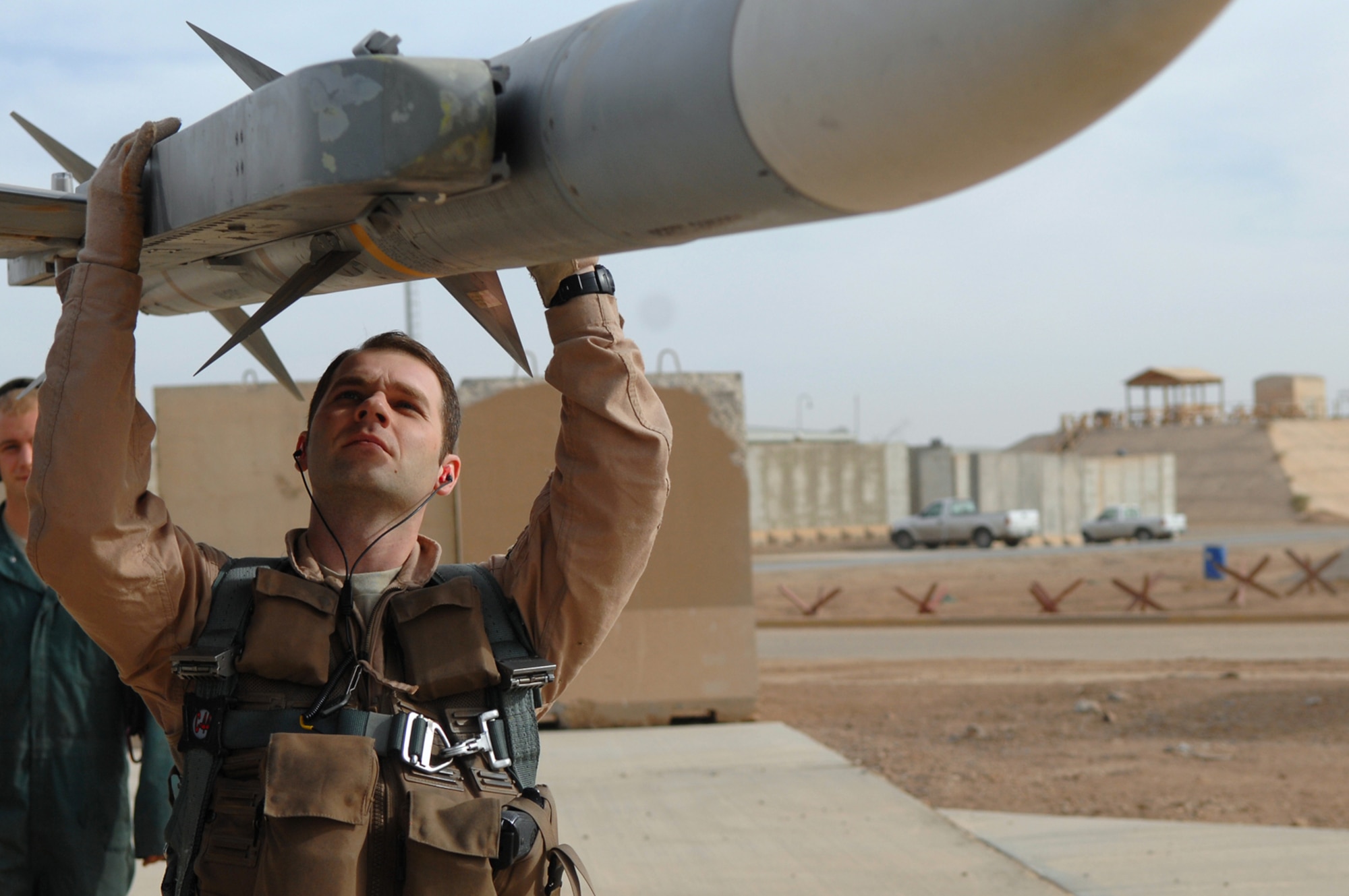 BALAD AIR BASE, Iraq -- Capt. D., 421st Expeditionary Fighter Squadron pilot, examines a munition on an F-16 Fighting Falcon as part of a pre-flight inspection here, April 18. As of the beginning of April, almost 5,000 close air support sorties had been flown by pilots throughout Iraq since the beginning of 2008, according to statistics provided by the Combined Air Operations Center. Captain D. is deployed from Hill Air Force Base, Utah. (U.S. Air Force photo/ Senior Airman Julianne Showalter) 