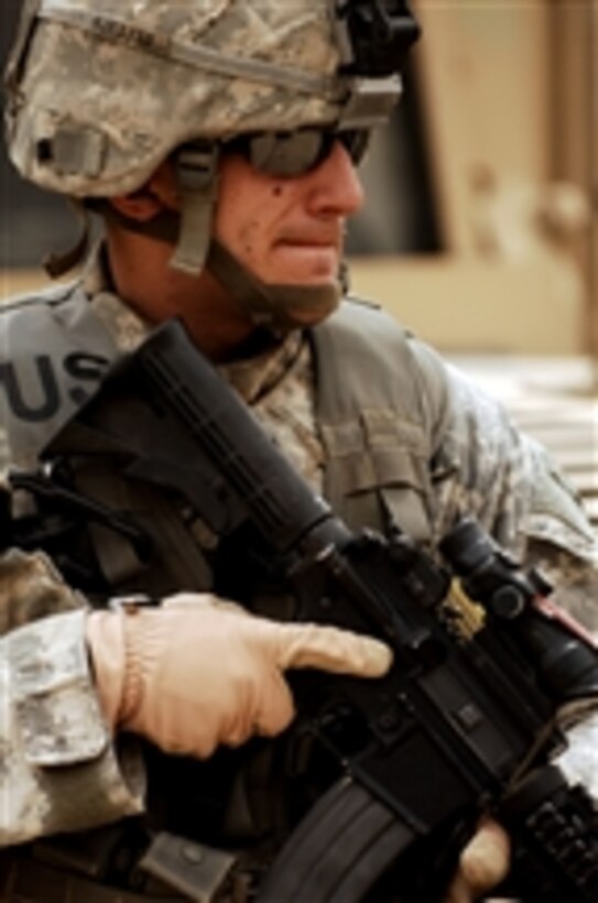U.S. Army Spc. Joe Kunkel from 3rd Special Troops Battalion, 3rd Brigade Combat Team, 4th Infantry Division provides security at Patrol Base Comanche in the Sadr City District of Baghdad, Iraq, on April 19, 2008.  