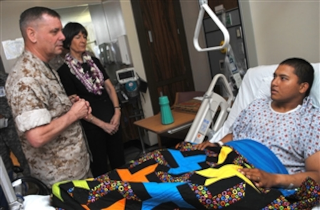 U.S. Marine Gen. James E. Cartwright, vice chairman of the Joint Chiefs of Staff, talks with U.S. Army Pvt. Joseph Miner at Tripler Army Medical Center, Honolulu, Hawaii, April 21, 2008. 