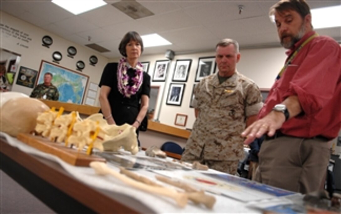 Dr. Tom Holland, scientific director of the Central Identification Laboratory, explains finding human remains to Vice Chairman of the Joint Chiefs of Staff U.S. Marine Gen. James E. Cartwright, center, and his wife, Sandee, during a trip to the Joint POW-MIA Accounting Command on Hickam Air Force Base, Honolulu, Hawaii, April 21, 2008. 