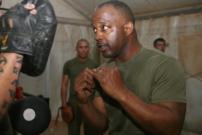 Master Sgt. Michael L. Stephens, communications chief for 2nd Light Armored Reconnaissance Battalion, Regimental Combat Team 5, demonstrates a solid combination of blows to an opponent during a daily boxing lesson at Camp Korean Village, Iraq, April 21. Stephens, 47, has served 28 years in the military, 22 with the Marine Corps, and is now on his second tour in Iraq.