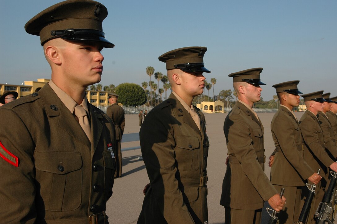 Twin brothers Nathan, left, and Samuel Watts stand at parade rest with their platoon during Battalion Commander’s Inspection Tuesday, as Company I Marines prepare for their graduation ceremony today. The twins will return to Marine Corps Base Camp Pendleton, Calif.,  following leave to go through the School of Infantry – together.