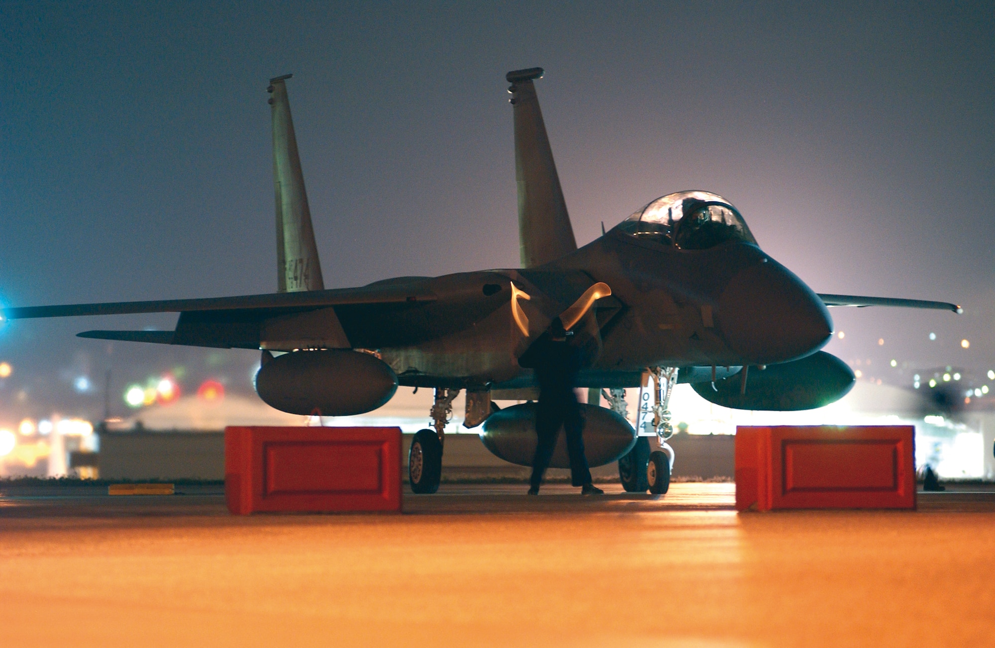 A Kadena Air Base crew chief prepares to marshal out an F-15C Eagle during the early morning hours here Wednesday before its departure to the U.S., symbolizing the end of the Iron Flow program here. The aircraft was one of three jets that left to be transferred to Air National Guard units under Iron Flow which exchanged Kadena's older F-15's with newer models from other active duty bases.  All the newer jets have been received and these were the last three older aircraft to be turned in.
(U.S. Air Force Photo/Senior Airman Jeremy McGuffin)
