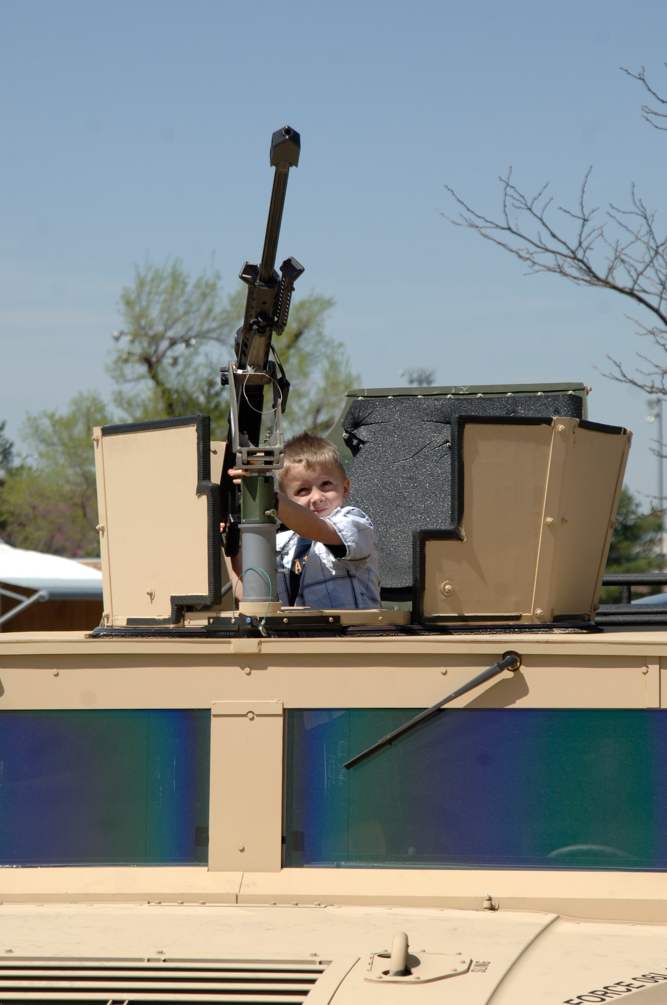 MCCONNELL AIR FORCE BASE, Kan. -- Ethan Allar, a Team McConnell family member, stands in a high-mobility, multipurpose vehicle while handling a .50-caliber rifle during the 10th annual Family Festival of Fun at the Robert J. Dole Center, April 19. Some 22nd Security Forces Squadron members attended the festival with a variety of items teach children about the security forces career.   (Photo by Staff Sgt. Ronald Lafosse)