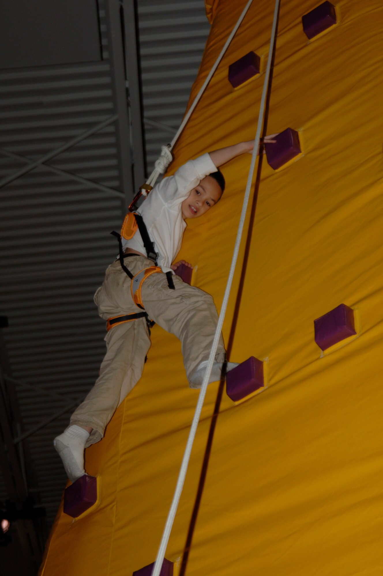 MCCONNELL AIR FORCE BASE, Kan. -- Thoren Jennings, a Team McConnell family member, climbs a king of the mountain inflatable during the 10th annual Family Festival of Fun at the Robert J. Dole Center, April 19.  Four other inflatables were set up during the 10th annual Family Festival of Fun that kept children jumping and climbing for hours.  (Photo by Staff Sgt. Ronald Lafosse)
