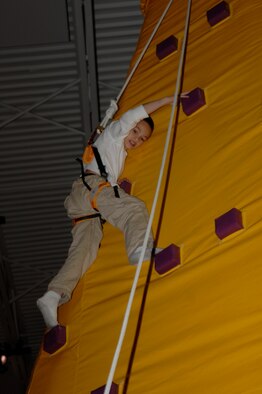 MCCONNELL AIR FORCE BASE, Kan. -- Thoren Jennings, a Team McConnell family member, climbs a king of the mountain inflatable during the 10th annual Family Festival of Fun at the Robert J. Dole Center, April 19.  Four other inflatables were set up during the 10th annual Family Festival of Fun that kept children jumping and climbing for hours.  (Photo by Staff Sgt. Ronald Lafosse)