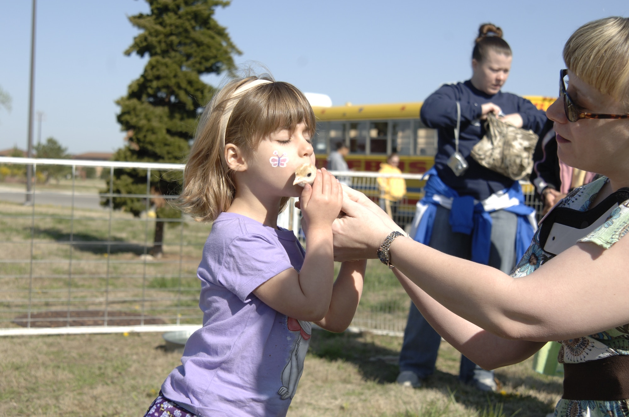MCCONNELL AIR FORCE BASE, Kan. -- Katie Hanovich, a Team McConnell family member, kisses a baby turkey during the 10th annual Family Festival of Fun at the Robert J. Dole Center, April 19. Some of the attractions at the festival were a petting zoo, pony rides, face painting and more.  (Photo by Staff Sgt. Ronald Lafosse)