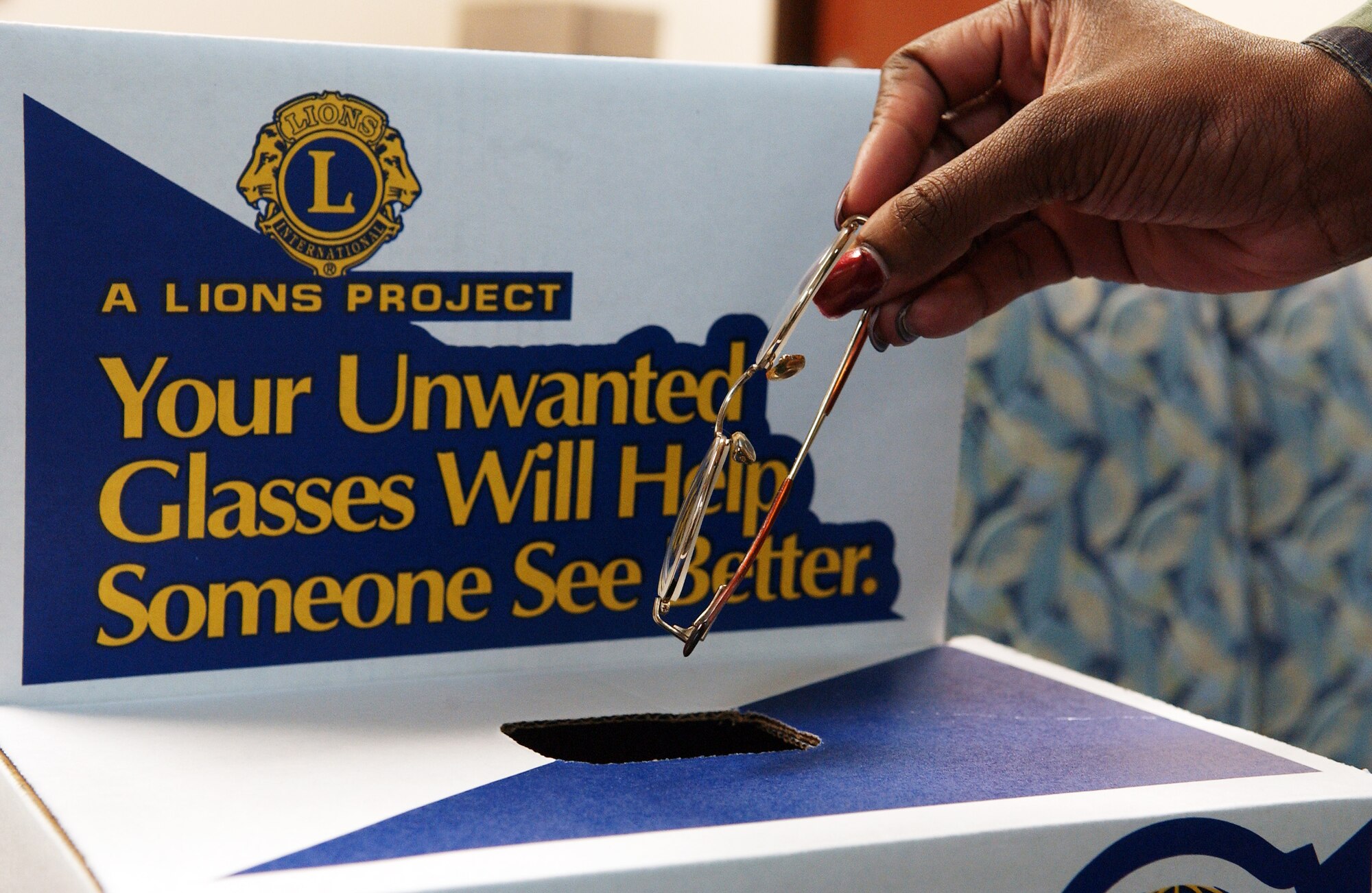 Staff Sgt. Shanequa Cox drops an old prescription of eye glasses into a Lions Foundation donation box April 22, 2008, at Eielson Air Force Base, Alaska. Every single pair of glasses donated are collected by the North Pole Lions Club then processed through their eye glass recycling and vision test center which helps provide under-privileged people with glasses. (U.S. Air Force Photo/Airman 1st Class Jonathan Snyder)