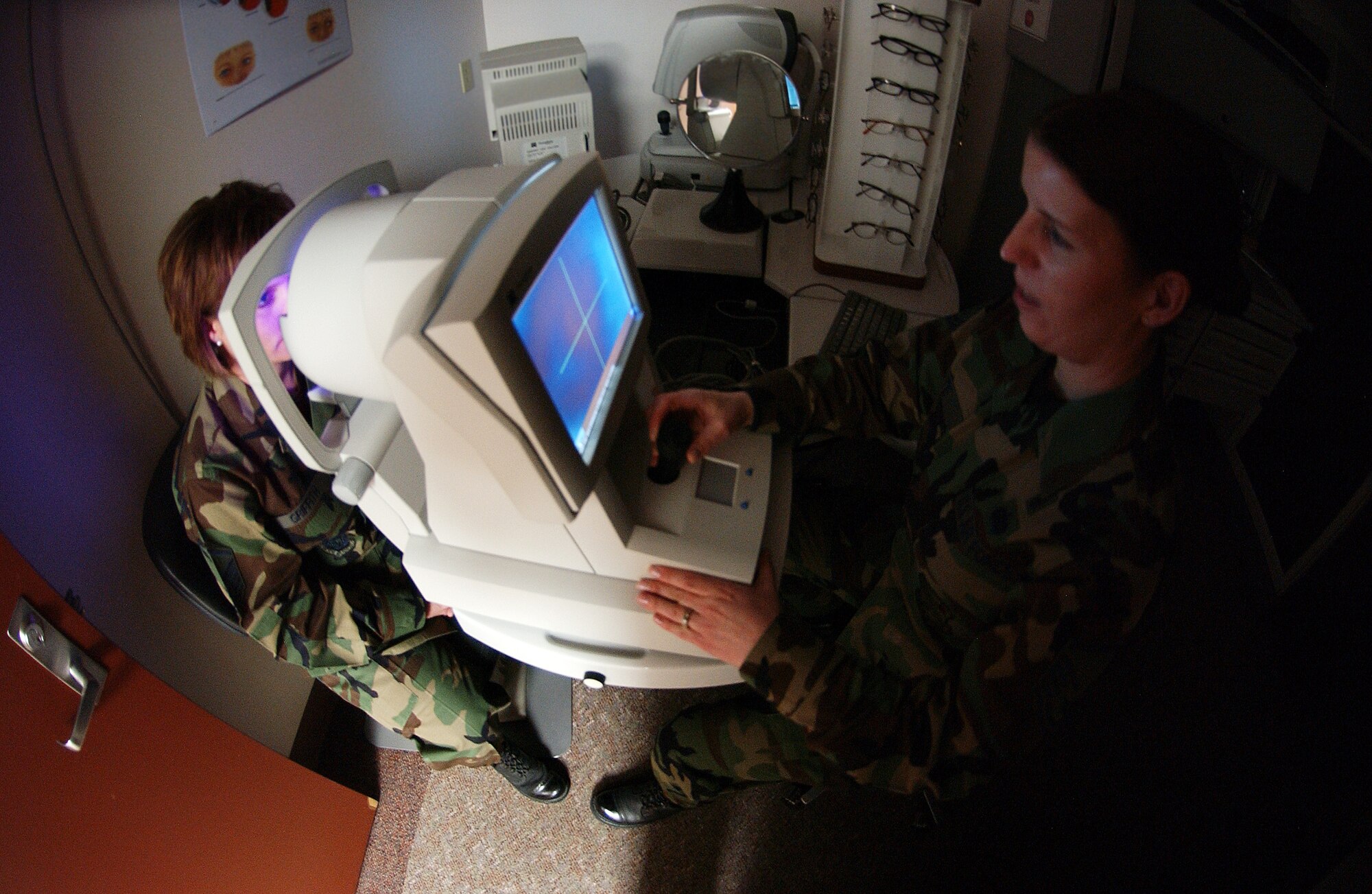 Master Sgt. Carmen Cate, right, takes a corneal topography photo of Master Sgt. Christine Griffith, left, eye April 22, 2008, at Eielson Air Force Base, Alaska. The 354th Medical Group eye clinic caters to active duty, dependants and retirees offering routine eye exams to corrective lens prescriptions. (U.S. Air Force Photo/Airman 1st Class Jonathan Snyder)