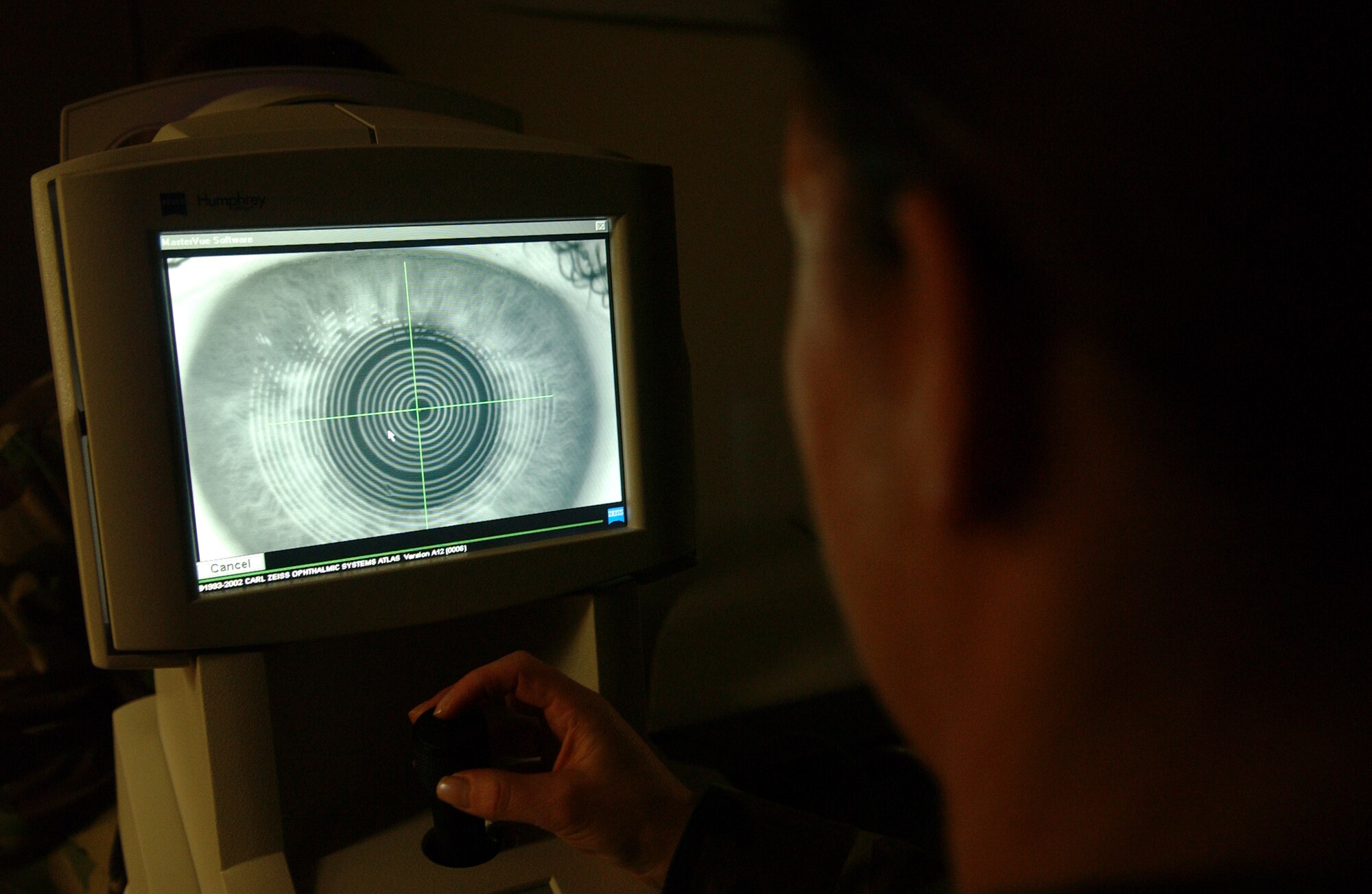 Master Sgt. Carmen Cate reviews a corneal topography photo of Master Sgt. Christine Griffith's eye April 22, 2008, at Eielson Air Force Base, Alaska. The result of the test will indicate if she is a good candidate for corrective laser eye surgery. The 354th Medical Group eye clinic caters to active duty, dependants and retirees offering routine eye exams to corrective lens prescriptions. (U.S. Air Force Photo/Airman 1st Class Jonathan Snyder)