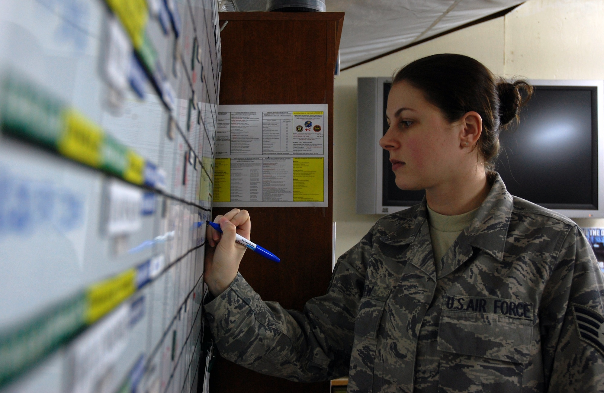 Staff Sgt. Amanda Chew updates a board used to give the unit's tactical operations center staff a ready reference on all ground convoy missions being conducted on March 3, 2008. Sergeant Chew is a controller for the 70th Medium Truck Detachment. Both the 70th and 424th MTDs fall under the 586th Expeditionary Logistics Readiness Squadron, the only combat-oriented LRS unit in the Air Force. (U.S. Air Force photo/Tech. Sgt. Michael O'Connor) 