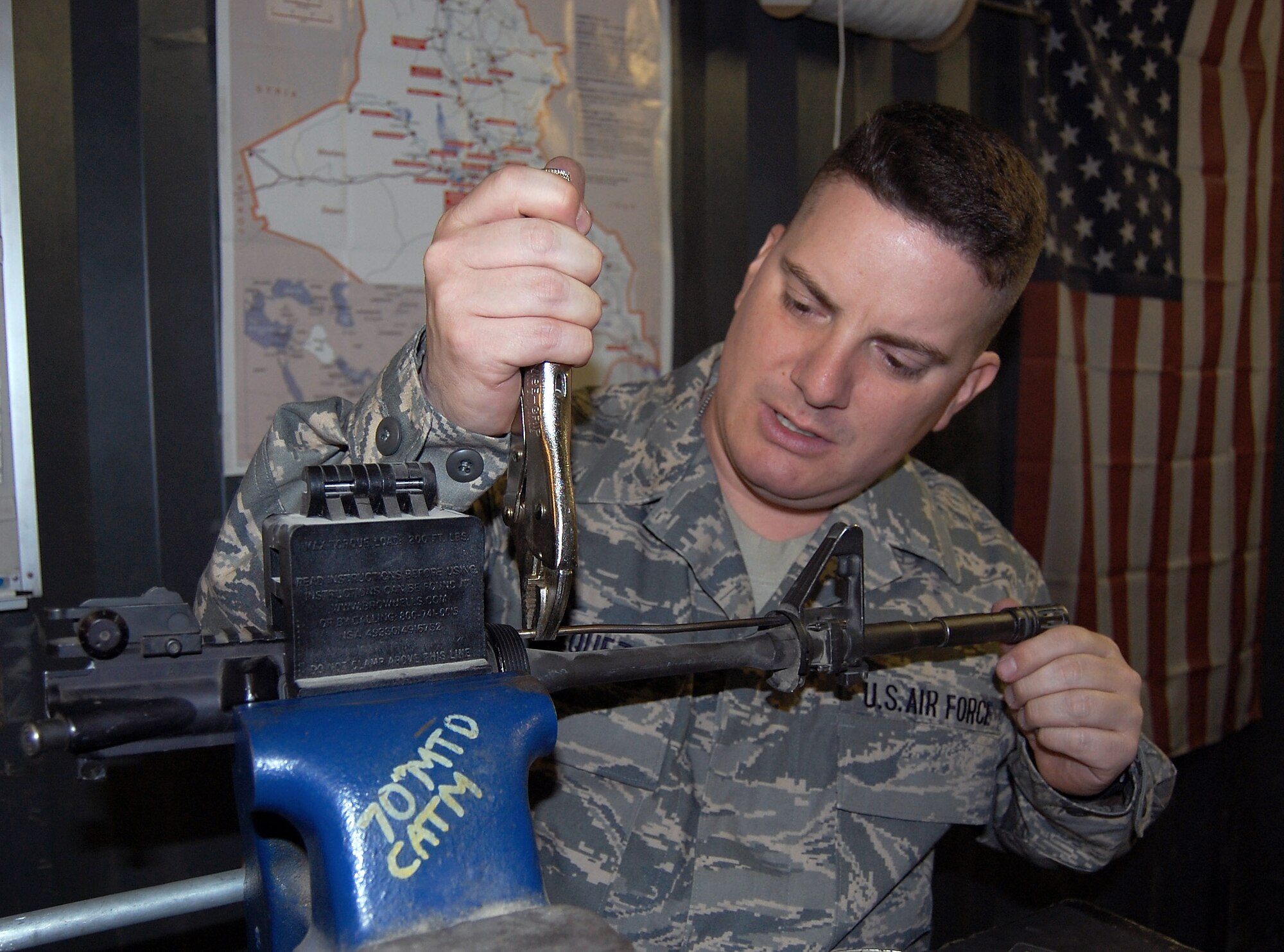 Master Sgt. Joseph Vasquez, performs maintenance recently on one of the weapons vehicle operators assigned to the 586th Expeditionary Logistics Readiness Squadron use while conducting combat convoy missions in Iraq. Sergeant Vasquez provides security and accountability of all weapons for the MTD, as well as issuing out weapons for each mission and doing any in-house maintenance on the weapons. Sergeant Vasquez is the NCO in charge of the 70th Medium Truck Detachment armory. (U.S. Air Force photo) 
