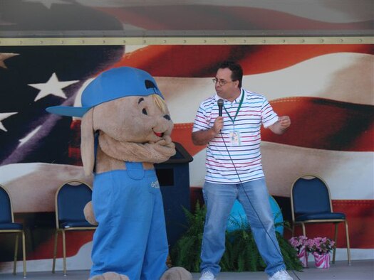 Sammy the Rabbit talks to Sam Renick, author or the children's book, "It's a Habit, Sammy Rabbit," about the importance of saving money outside of Pope Elementary School April 18. (U.S. Air Force Photo)