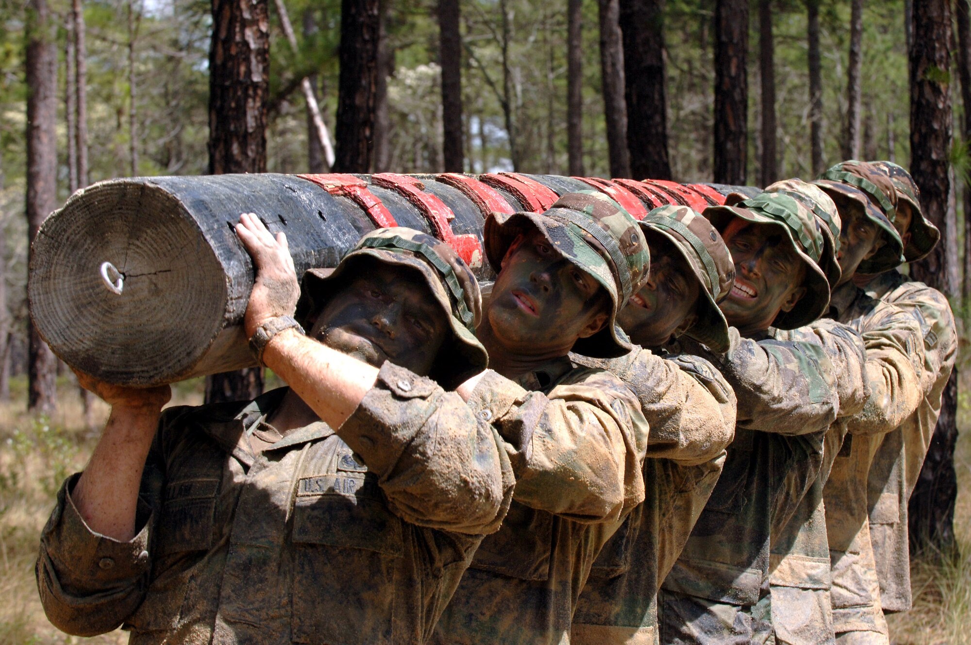 Combat control students from Pope Air Force Base’s 342nd Training Squadron maneuver the “teamwork” log April 9 during a “monster mash” event of the combat control school field training exercise at Fort Bragg, which is adjacent to Pope. The monster mash is an endurance event to build individual stamina and encourage teamwork. (U.S. Air Force Photo by Master Sgt. Scott Reed)