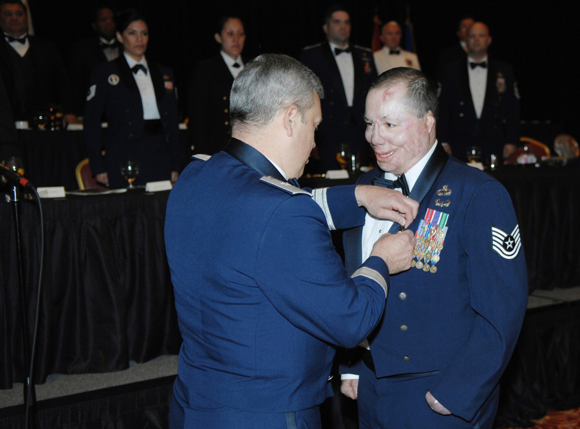 NELLIS AIR FORCE BASE, Nev. -- Tech. Sgt. Israel Del Toro, Jr., a 759th Medical Support Squadron member at Lackland AFB, Texas, receives the Air Force Combat Action Medal at the National Image Conference held at the South Point Hotel and Casino on April 17  in Las Vegas. He is being pinned on by Brig. Gen. Michael Longoria, commander of the 93rd Air Ground Operations Wing, Moody AFB, Ga. (U.S. Air Force Photo by/Airman First Class Brian Ybarbo)