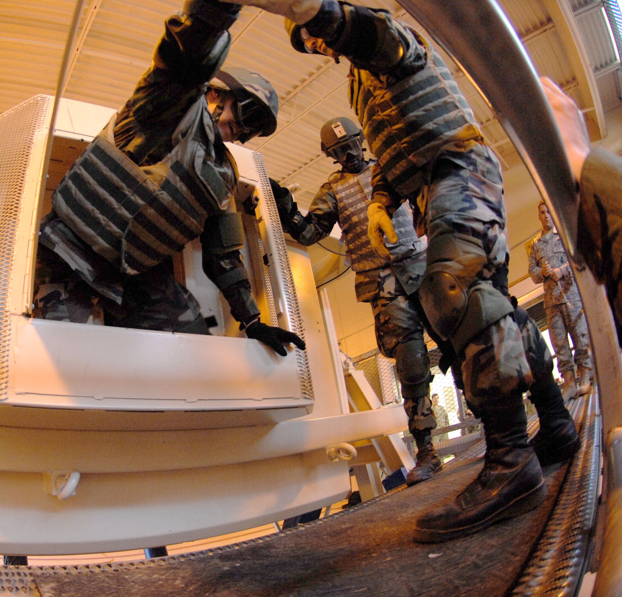 MOODY AIR FORCE BASE, Ga. – Members of the 23rd Civil Engineering Squadron exit the Humvee egress assistance trainer here April 23.  The intended purpose of the HEAT is for combat Airmen to achieve self-control and overcome natural fear and panic following a vehicle rollover. (U.S. Air Force photo by Senior Airman Angelita Lawrence)