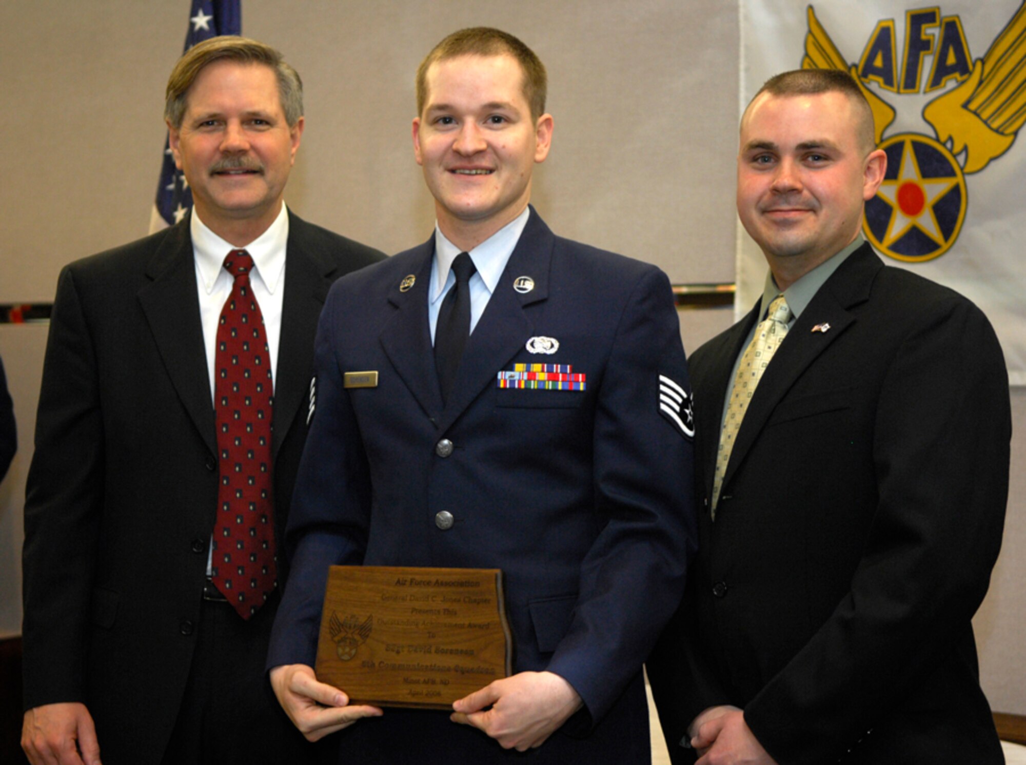 MINOT AIR FORCE BASE, N.D. -- Staff Sgt.  David Sorensen, 5th Communications Squadron, was one of the 35 base winners presented with an Air Force Association award at a ceremony April 15 at the Grand International Inn, Minot. Also pictured is North Dakota Governor John Hoeven who presented the awards, and local Air Force Association chapter president Capt. Michael Provencher, 741st Missile Squadron.  (U.S. Air Force photo by Senior Airman Joe Rivera)