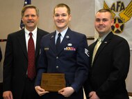 MINOT AIR FORCE BASE, N.D. -- Staff Sgt.  David Sorensen, 5th Communications Squadron, was one of the 35 base winners presented with an Air Force Association award at a ceremony April 15 at the Grand International Inn, Minot. Also pictured is North Dakota Governor John Hoeven who presented the awards, and local Air Force Association chapter president Capt. Michael Provencher, 741st Missile Squadron.  (U.S. Air Force photo by Senior Airman Joe Rivera)