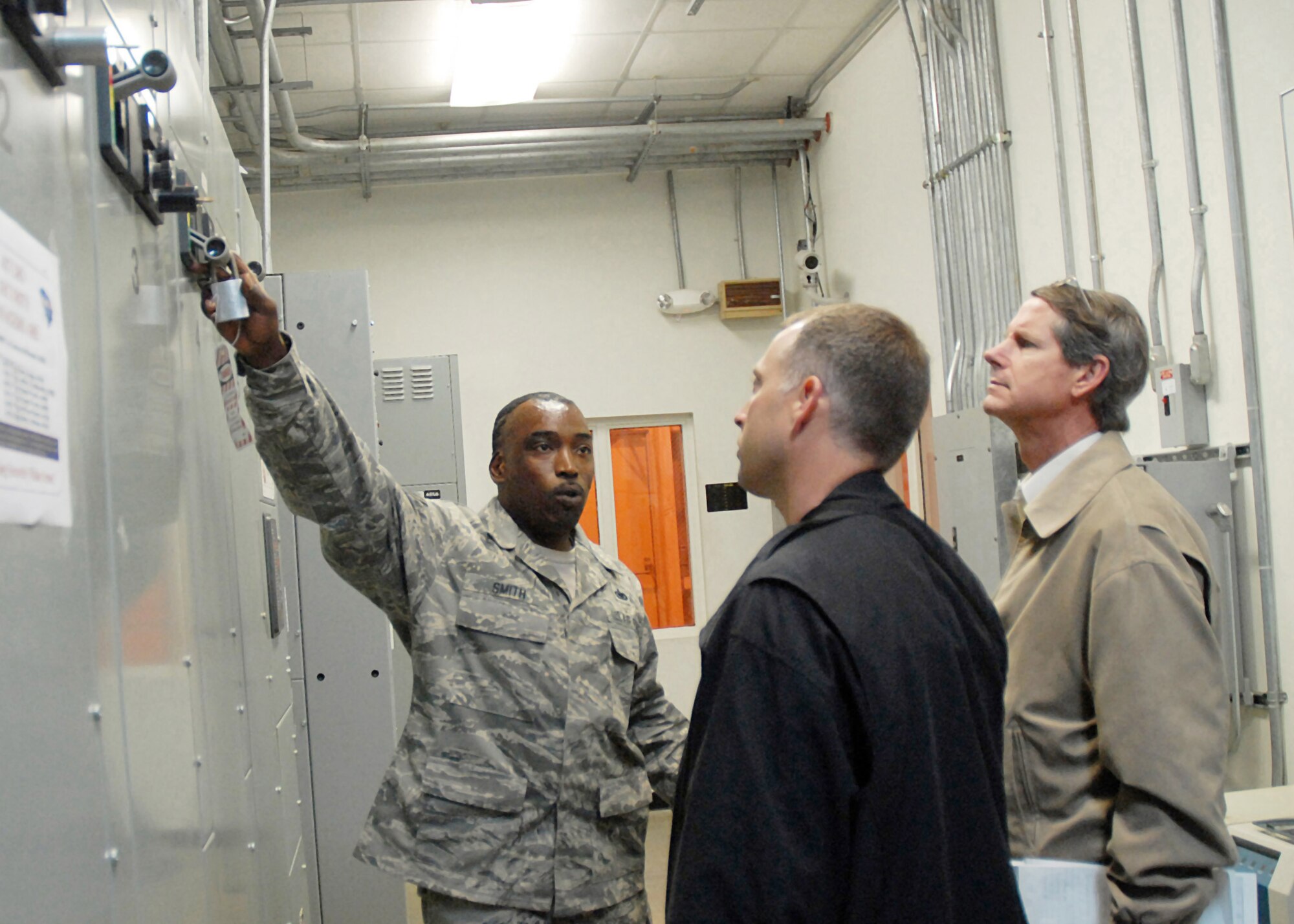 Staff Sgt. Richard Smith explains emergency procedures for flightline fuel pumps to Philip Driskill (center) and Donn Brown (right) of the Air Mobility Command Voluntary Protection Program assessment team.  The team was visiting Charleston Air Force Base, S.C. prior to implementing the VPP program there.  Sergeant Smith is a fuels hydrants supervisor for the 437th Logistics Readiness Squadron Fuels Management Flight. The aim of VPP is to help Airmen take ownerships in preventing safety and health mishaps.  (U.S. Air Force photo/Staff Sgt. Jennifer Arredondo)