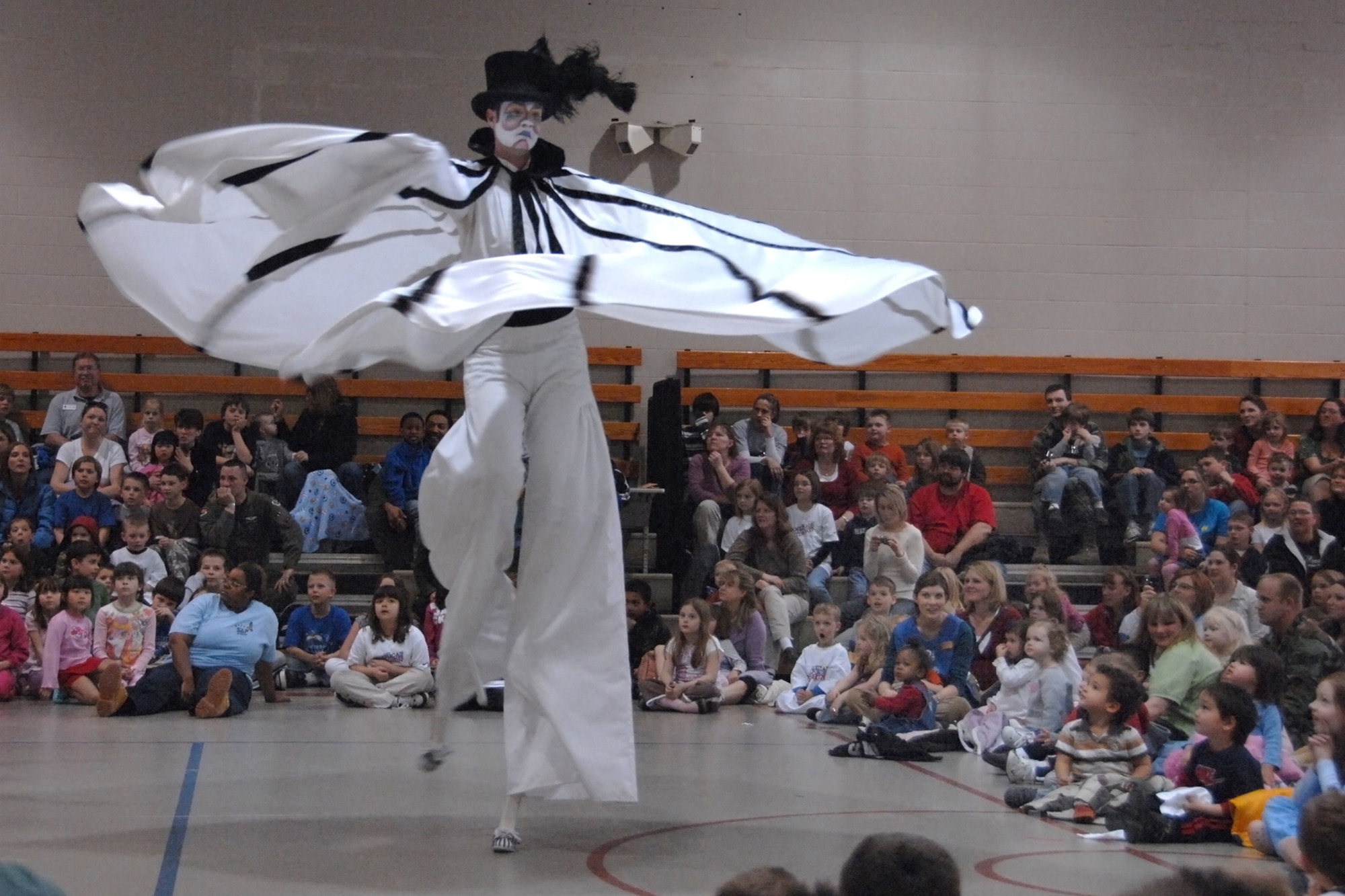 Cirque du Soleil performer ‘Creator’ wows Offuttchildren with his stilt-walking twirling skills. The Cirque de Soleil’s Saltimbanco touring troupe came to Offutt as part of a special ‘Month of the Military Child’ event during their regular promotional stops for their show in Omaha. (U.S. Air Force Photo/Josh Plueger)