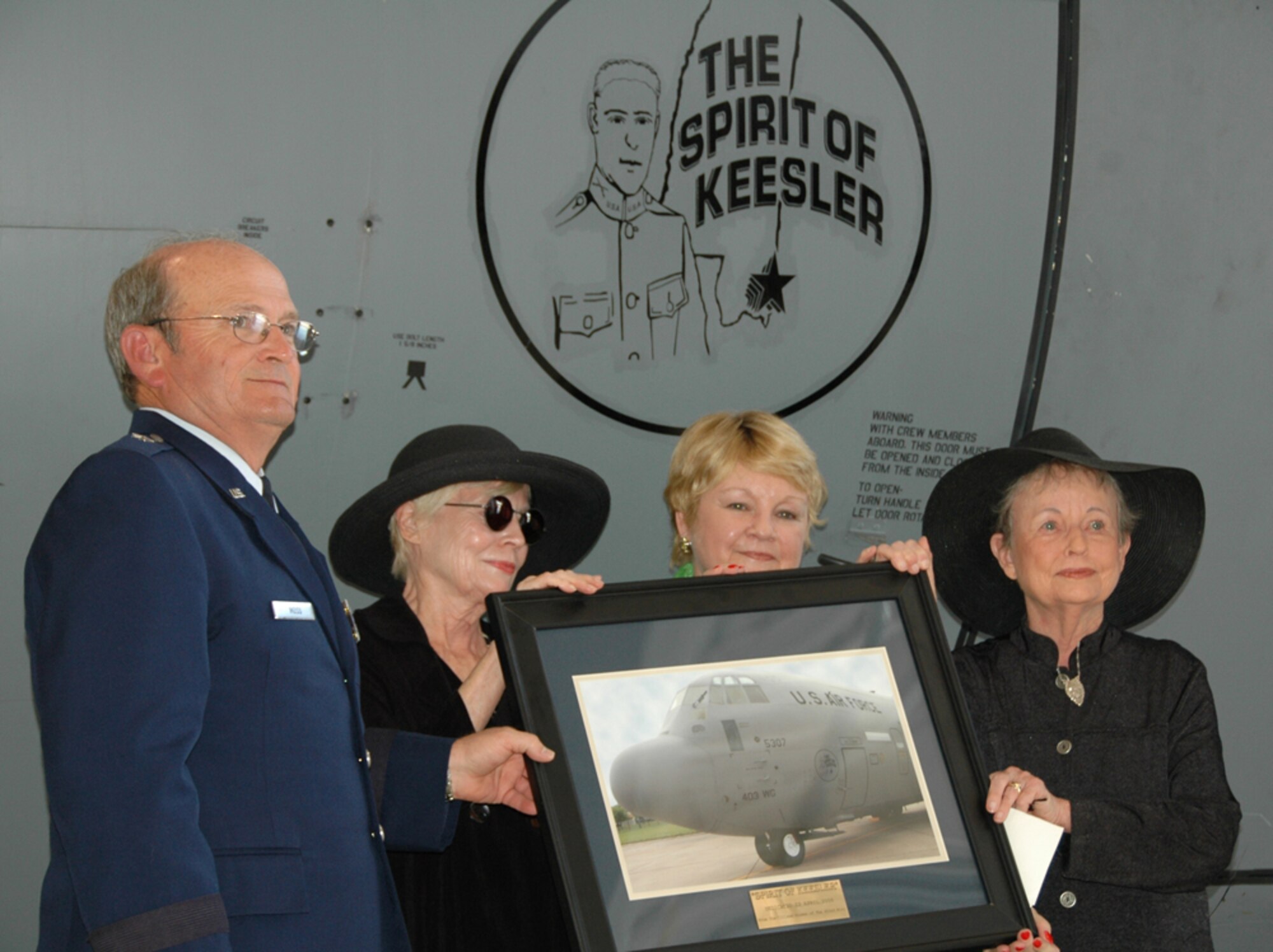 KEESLER AIR FORCE BASE, Miss. -- Presenting the nieces of 2nd Lt. Samuel Reeves Keesler  with a commemorative photo of the newly dedicated Spirit of Keesler WC-130J aircraft is Brig. Gen. Richard Moss, commander, 403rd Wing. Among the family members and descendants of Lieutenant Keesler who attended the ceremony were (from left) Clara Wise-Wolf, Charlot Morrison and Isabel Miller. (U.S. Air Force Photo/Tech. Sgt. Ryan Labadens)