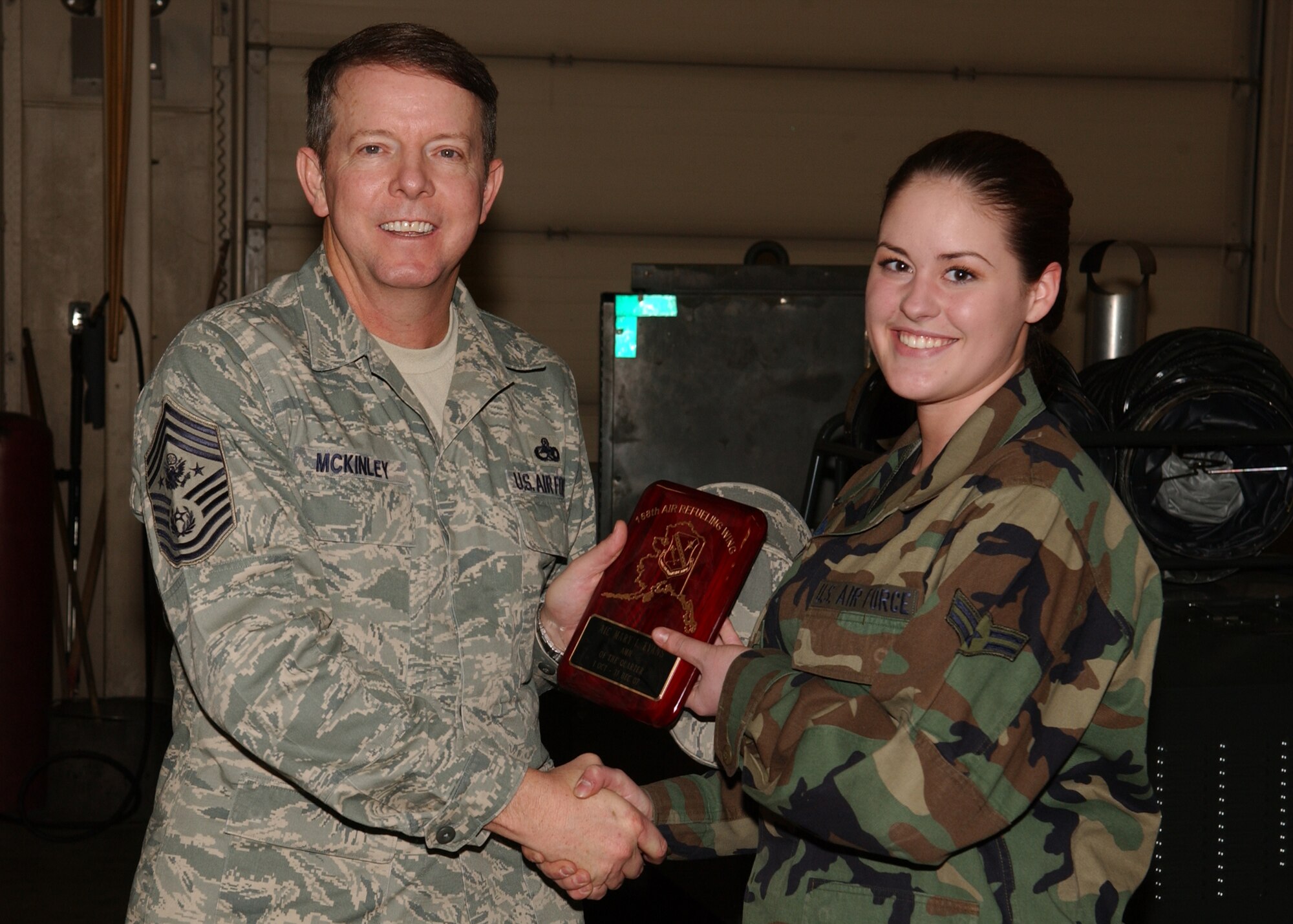 Chief Master Sergeant of the Air Force, Chief Master Sgt. Rodney McKinley, coins Airman 1st Class Mary Evans, 168th Maintenance Squadron during a recent visit to the base. Airman Evans was coined for outstanding performance from October through December 2007. Other Icemen coined by the Top of the World Chief's Group were coined by Chief Master Sgt. David Christmas of the 354th MXS, they are: Staff Sgt. Jeffrey Koczak, 354th MXS, for outstanding leadership; Senior Airman Brent Boudreaux, 354th MXS, for exceptional performance; and Staff Sgt. Anthony Sperry, 354th MXS, for outstanding leadership. (U.S. Air Force photo by Airman 1st Class Jonathan Snyder)                     