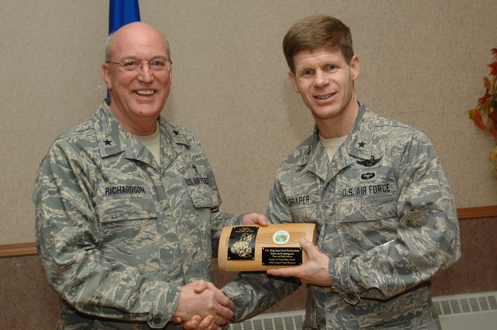 354th Fighter Wing commander, Brig. Gen. Mark Graper presents the guest speaker, Air Force deputy chief of chaplains, Brig. Gen. Cecil R. Richardson with a section of the old chapel balcony railing during the National Prayer Breakfast, Eielson Air Force Base, Alaska, April 16, 2008.  (U.S. Air Force photo/Staff Sgt. Tia Schroeder)