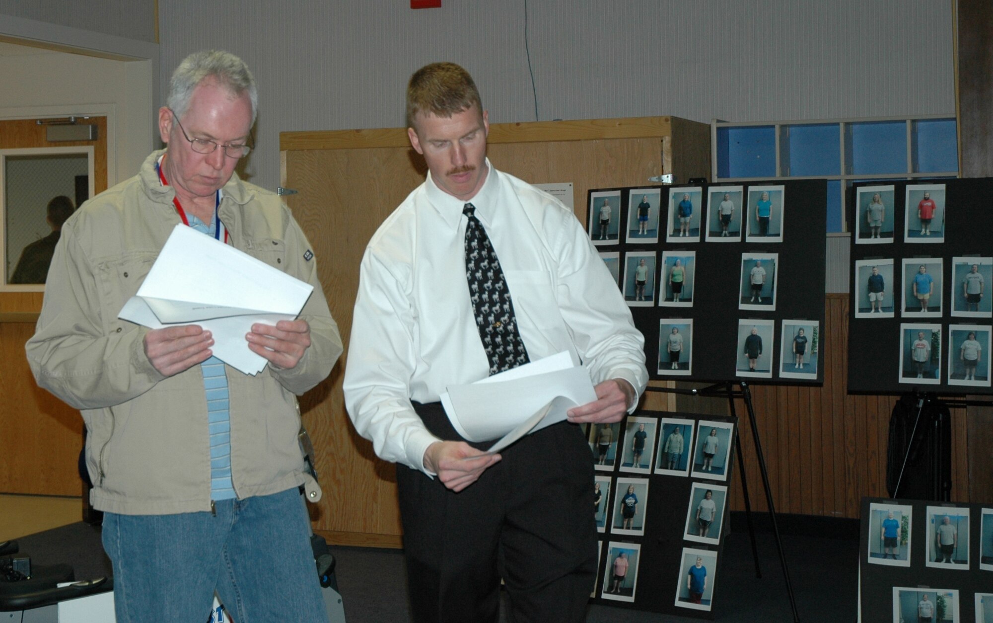 Kirk Clark and Roger Barnes look over the data graphs compiled during the course of the Largest Loser program. The graphs tracked trends for each of the three categories being assessed – weight loss, abdominal circumference and body fat percentage. Mr. Clark is the exrecise physiologist at the Health and Wellness Center here and Mr. Barnes was this season's largest loser in abdominal circumference, having lost 5 inches. (U.S. Air Force photo/Valerie Mullett)