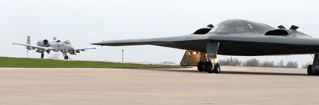 A B-2 Spirit (right) from the 509th Bomb Wing is taxied past an A-10 from the 442nd Fighter Wing at Whiteman Air Force Base, Mo., April 17.  Both units are based at Whiteman.  The 509th is an active-duty unit while the 442nd is under Air Force Reserve Command.  (U.S. Air Force photo/Tech. Sgt. Samuel A. Park)