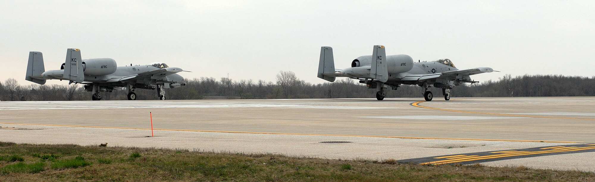 Two A-10 Thunderbolt IIs stand by on the runway awaiting clearance from the air traffic control tower for take-off from Whiteman Air Force Base, Mo., April 17. The A-10s are piloted by members of the 303rd Fighter Squadron, part of the 442nd Fighter Wing, an Air Force Reserve Command unit at Whiteman. (U.S. Air Force photo/Tech. Sgt. Samuel A. Park)
